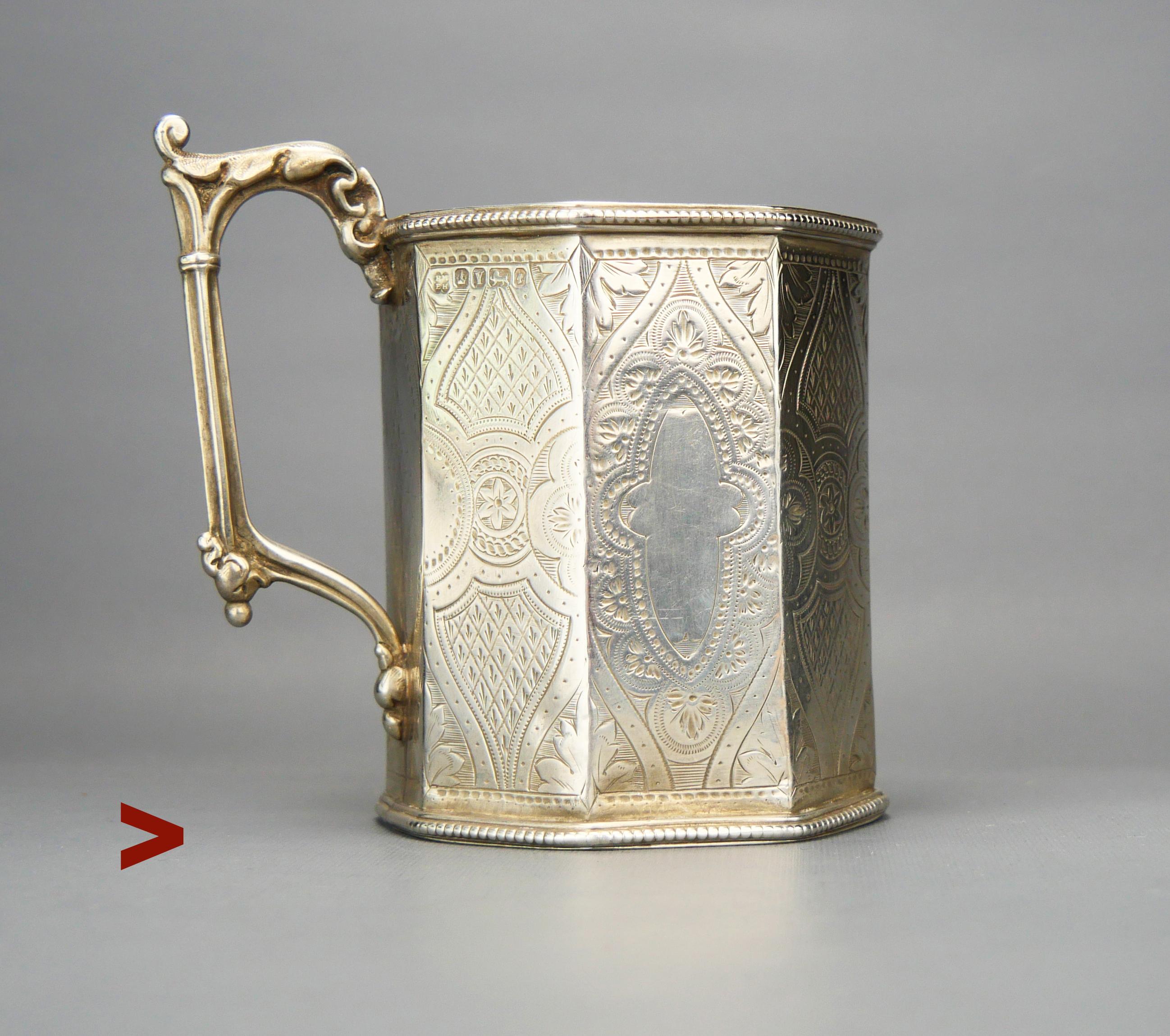 Victorian  Sterling Silver Cup, thick walled, with hand - engraved ornaments on all sides except the bottom. Vacant cartouche.

This cup has a full set of conventional British hallmarks : maker is Martin Hall & Co , town mark of Sheffield and date