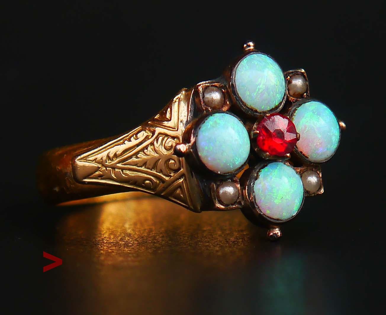 155 years old  Flower Ring in excellent condition.

Four bezel set natural Opal  settings Ø 4.25 mm/ 0.28ct each + one old diamond cut / claw set rosy Red Garnet setting Ø 4mm/0.25ct + four tiny Seed Pearls. Opals are colorful and bright and give