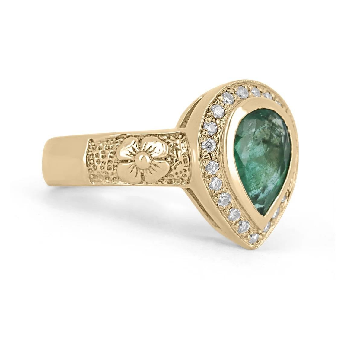 A stunning emerald and diamond right-hand ring. The gemstone carries a full 1.61-carat, pear-cut Zambian emerald with great color and qualities. Surrounding the emerald is a brilliant round cut diamond halo, pave set. An intricate floral design