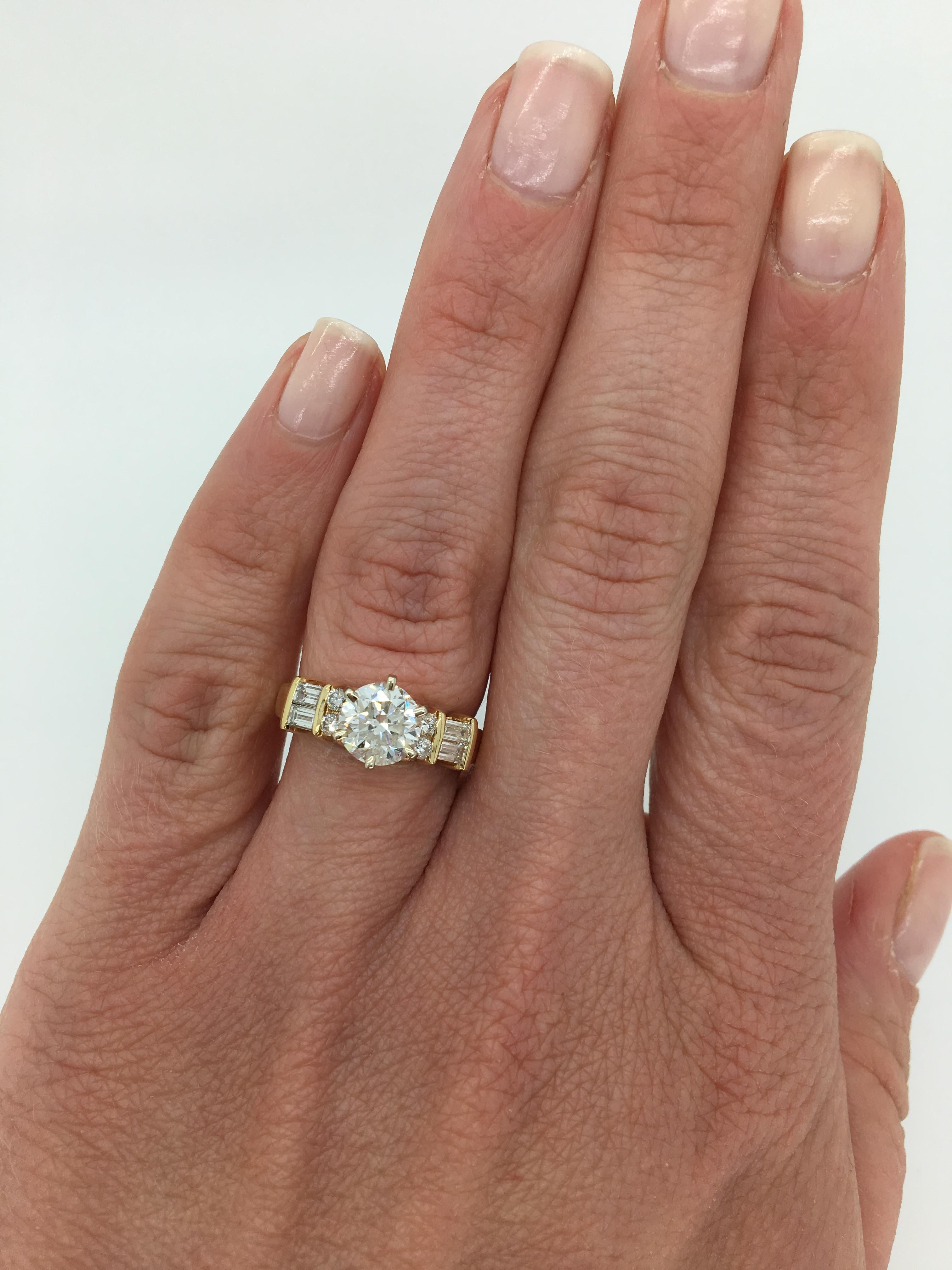 14K yellow gold approximately 1.37CT  Round Brilliant Cut diamond engagement ring with classic baguette and round brilliant cut diamond accents. 

Center Diamond Carat Weight: Approximately 1.37CT
Center Diamond Cut: Round Brilliant Cut
Center