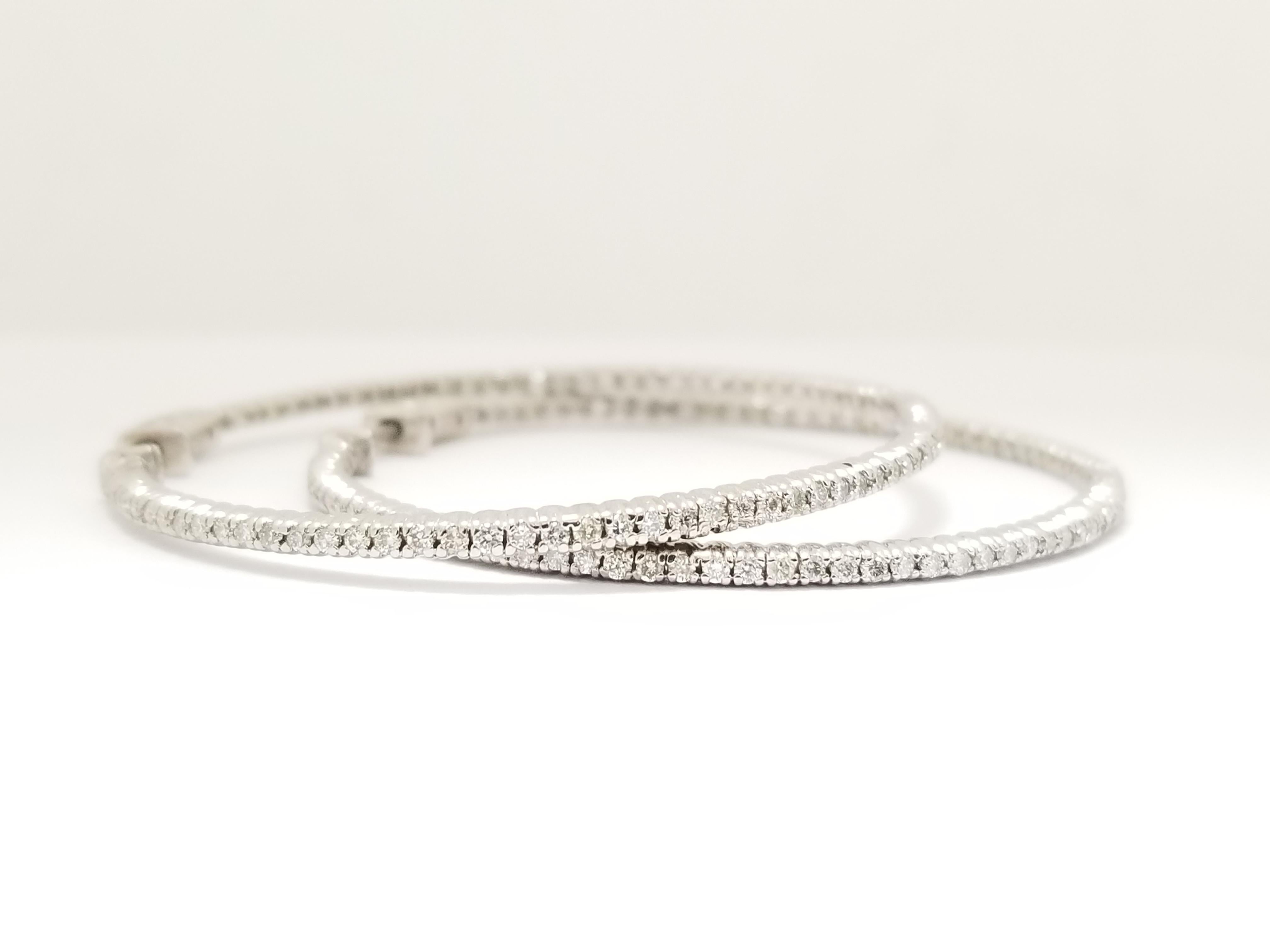 Beautiful pair of diamond inside out hoop earrings in 14k white gold. Secures with snap closure for wear.  Measures 1.75 inch in diameter. Very Shiny and clean, average I Color, vs Clarity,  Perfect for the any occasion! 