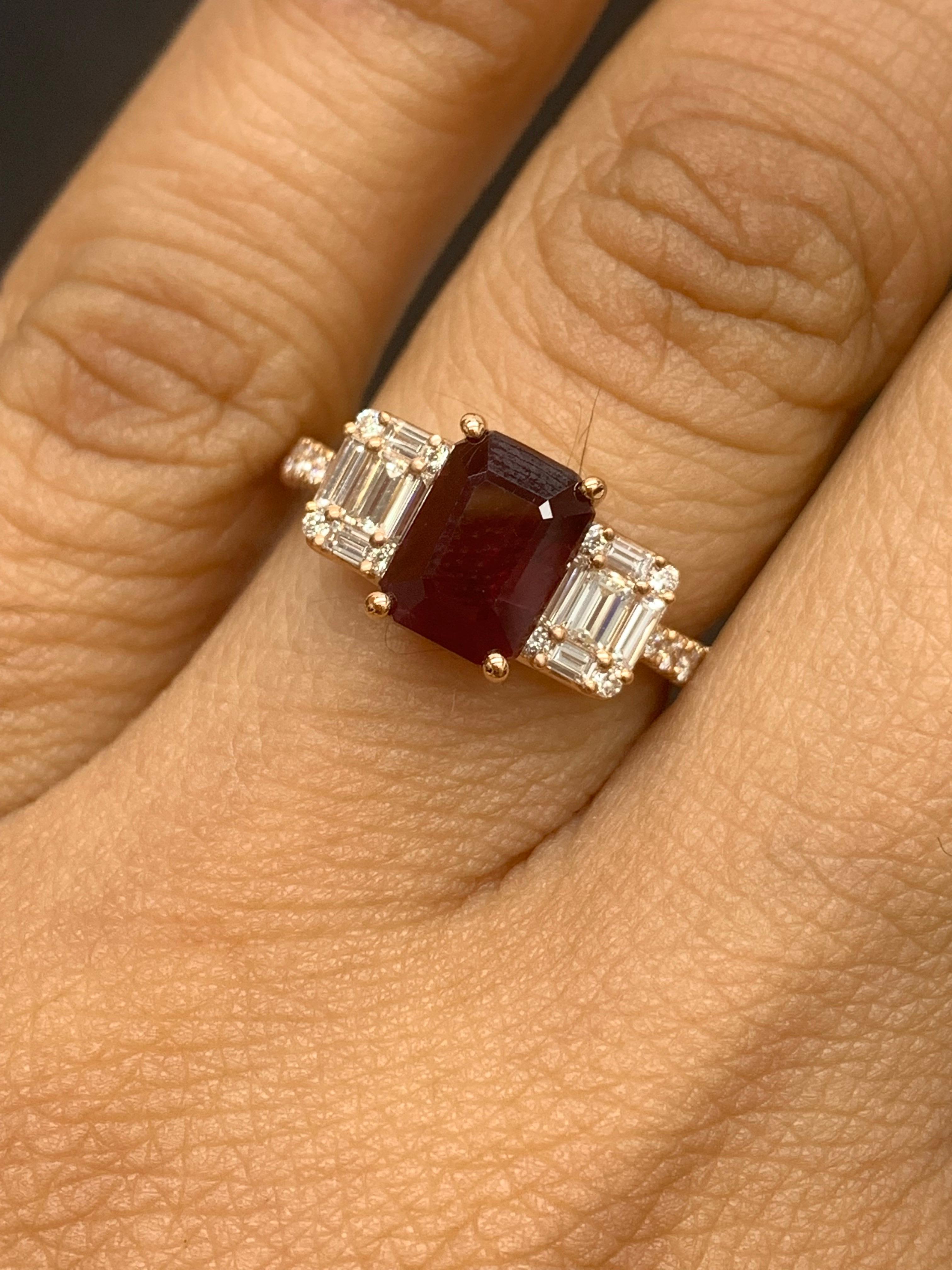 A stunning ring showcasing a rich emerald cut Ruby weighing 1.87 carats surrounded by diamonds on both sides. 28 diamonds on each side weighing 0.58 carats in total. Made in 18K Rose Gold.