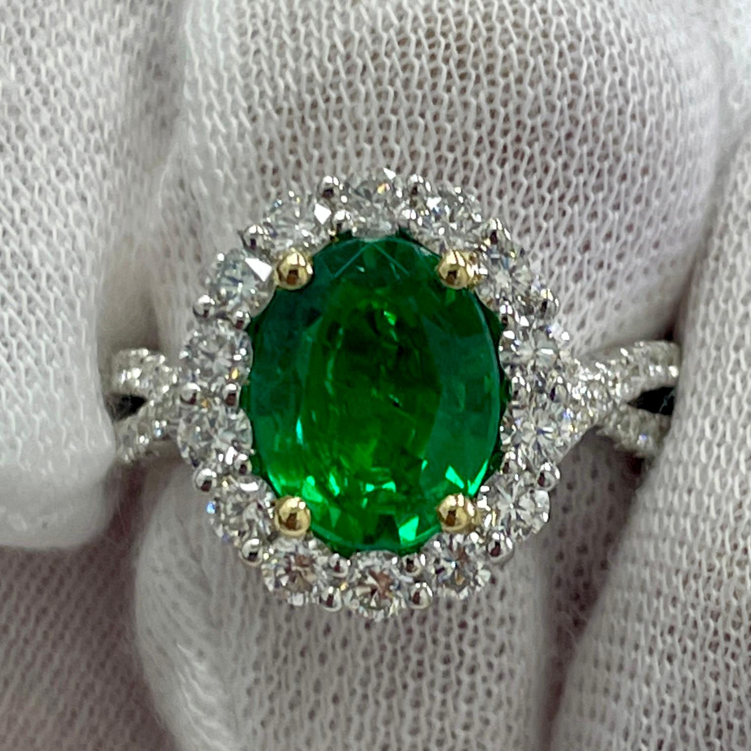 This is a LIVELY emerald with an open color, mounted in an elegant 18K white gold [with a yellow gold basket] and diamond ring with 1.06Ct of brilliant white diamonds. Suitable for any occasion!