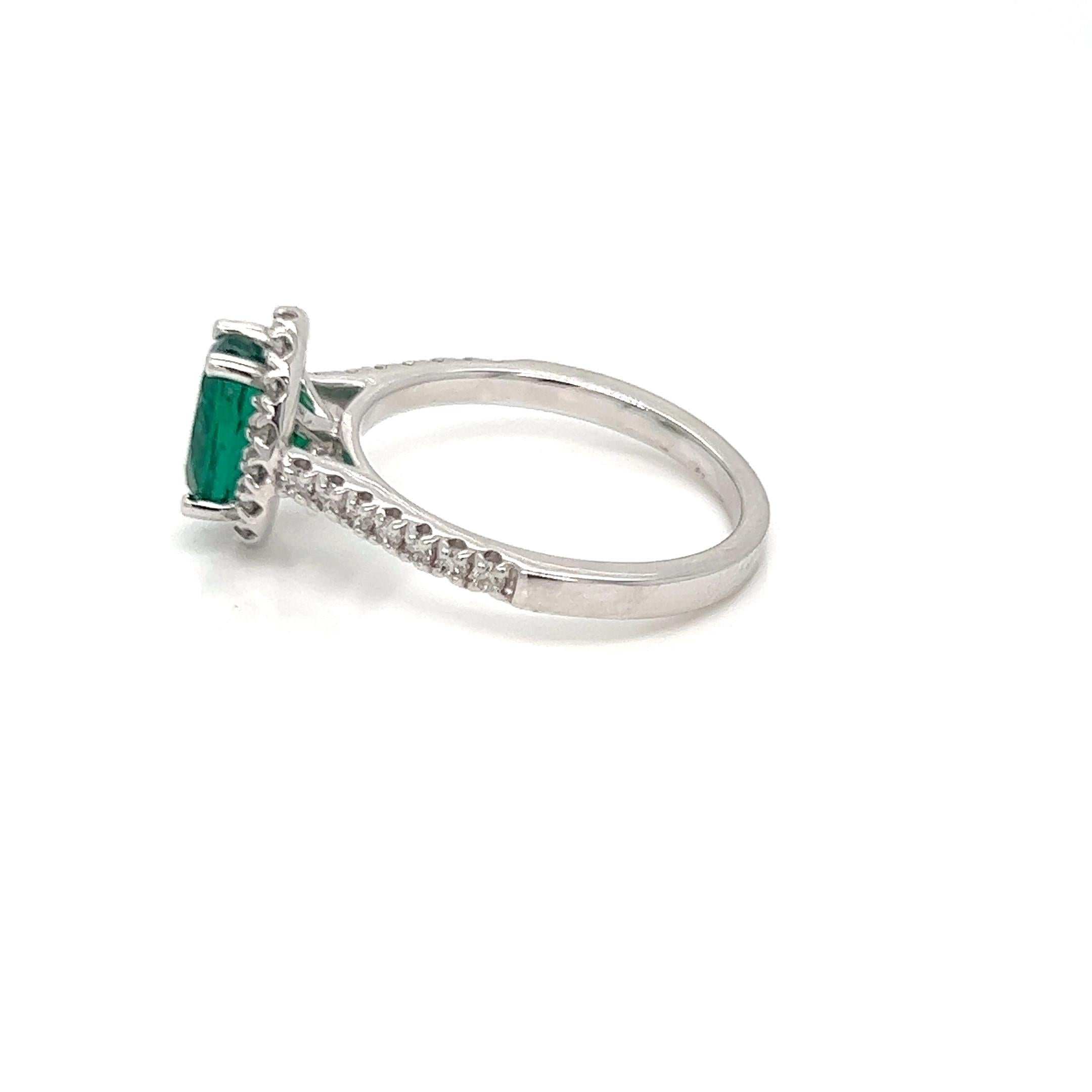 Presenting our magnificent 1.87 carat Oval Cut Zambian Emerald and Diamond Halo Engagement Ring, a magnificent work of art that radiates class and refinement. This ring is as distinctive as your love tale, fusing the ageless charm of a Zambian