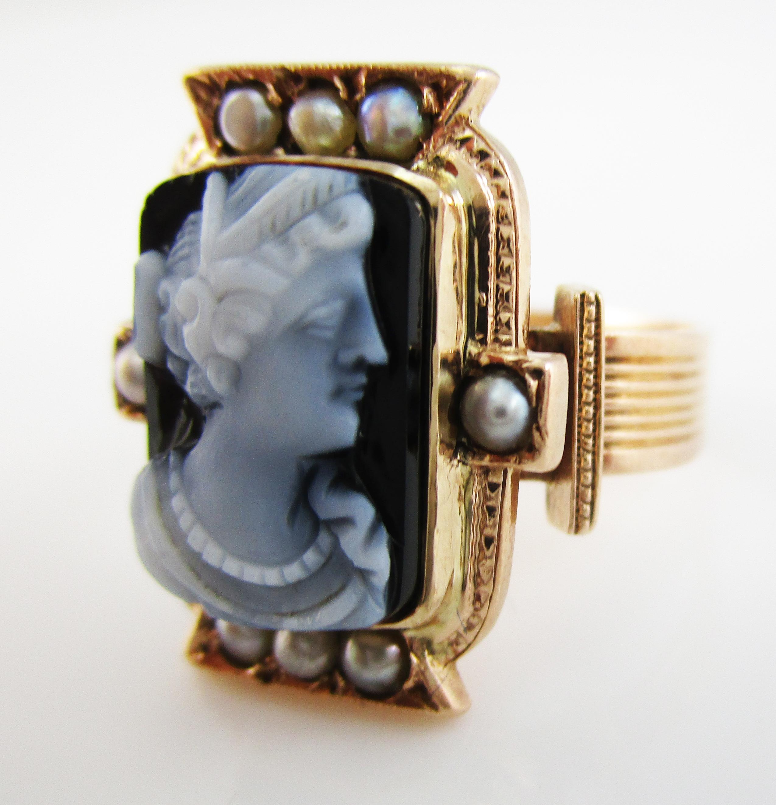 This magnificent Etruscan ring is in 14k rose gold and features a beautifully carved agate cameo center with a white face and black background! The rose gold serves as the perfect frame for the lovely, fine details of the carving of a distinguished
