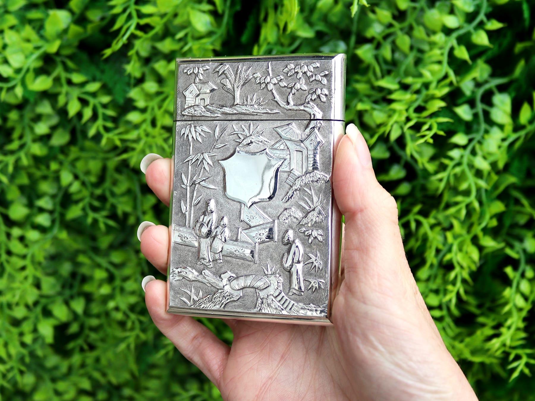 An exceptional, fine and impressive antique Chinese Export Silver card case; part of our diverse Asian silverware collection

The anterior surface of this rare Chinese silver card case is ornamented with chased oriental figures amidst bamboo and