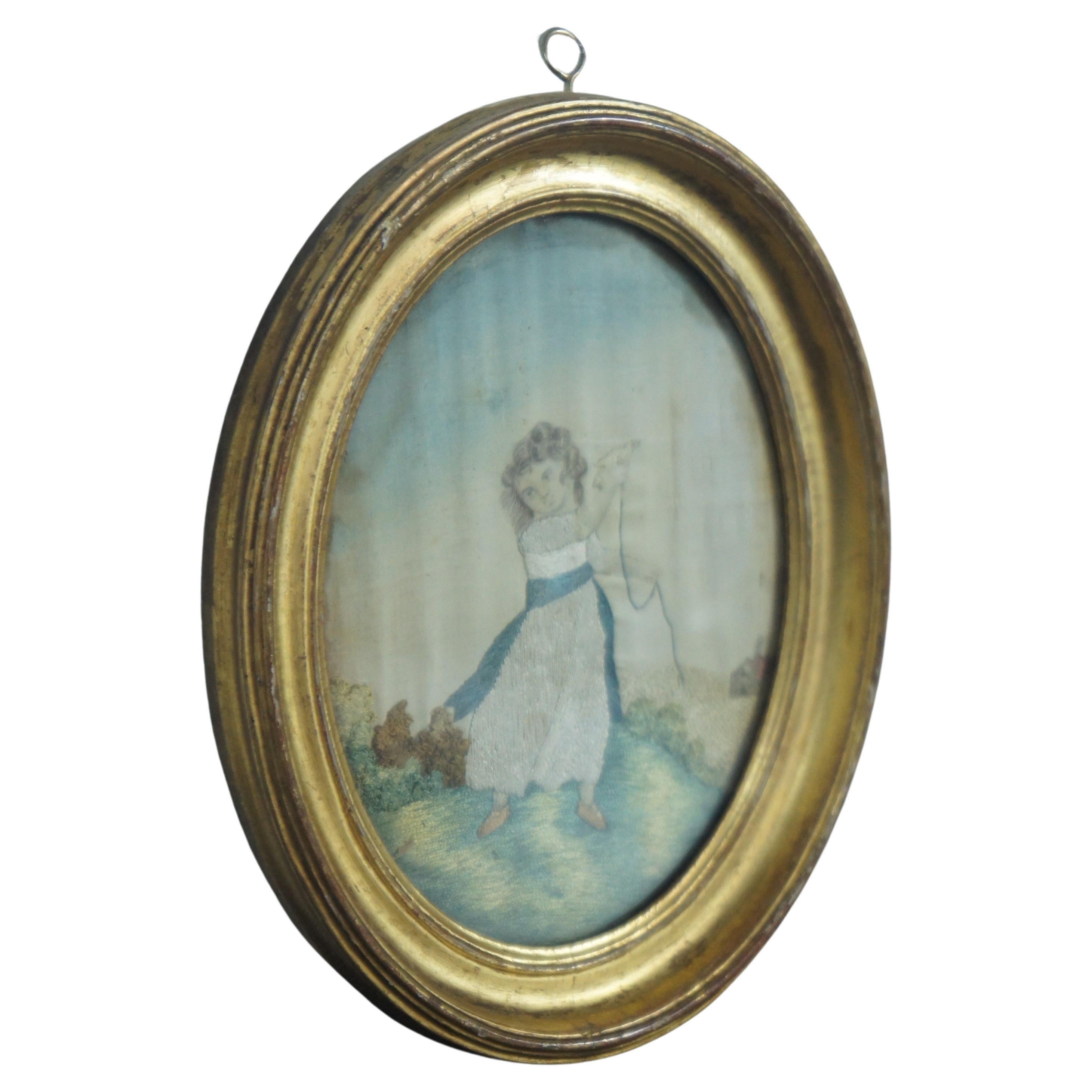 Antique French silk embroidered stumpwork picture of a young girl on a hill, holding a bird tied to a string, with a cottage in the background. Some history included along the back, but hard to read.