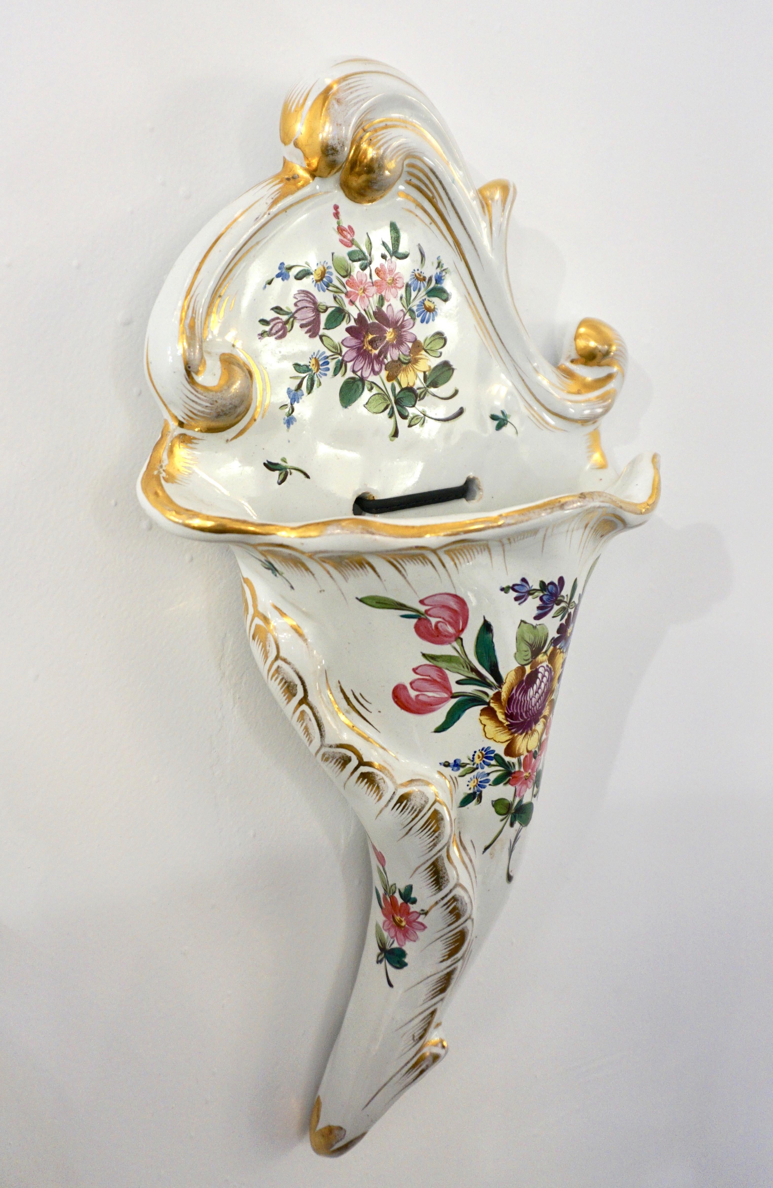 A delightful cornucopia-shaped Faience wall decoration signed Angoulême, a flower holder wall pocket in ivory white tin-glazed earthenware, hand-painted with delicate flowers and gold accents, with the typical 19th-century romanticism of the time