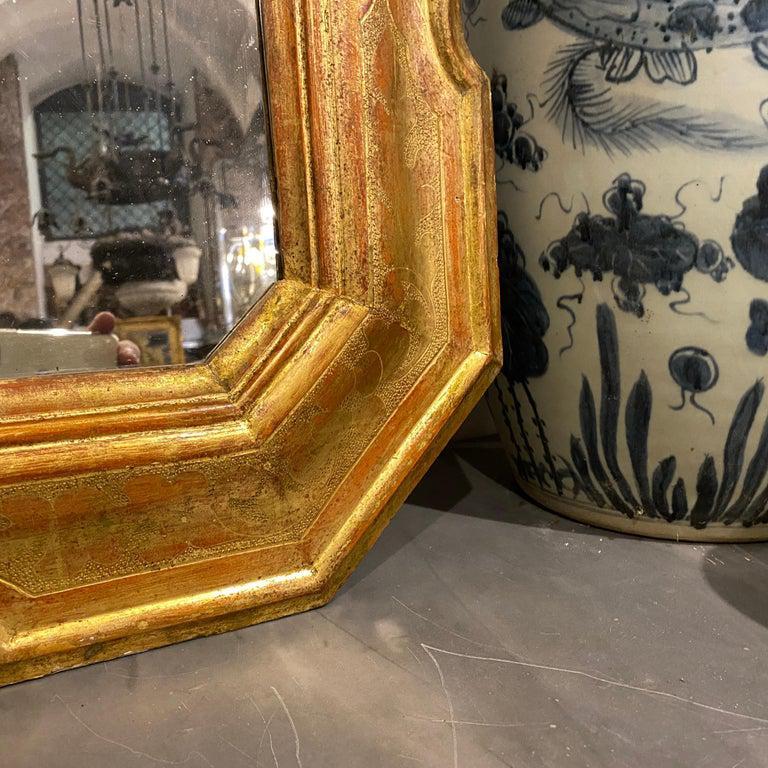 A gilded wood wall mirror made in Sicily, it's hand crafted and painted and in good conditions considering use and age.