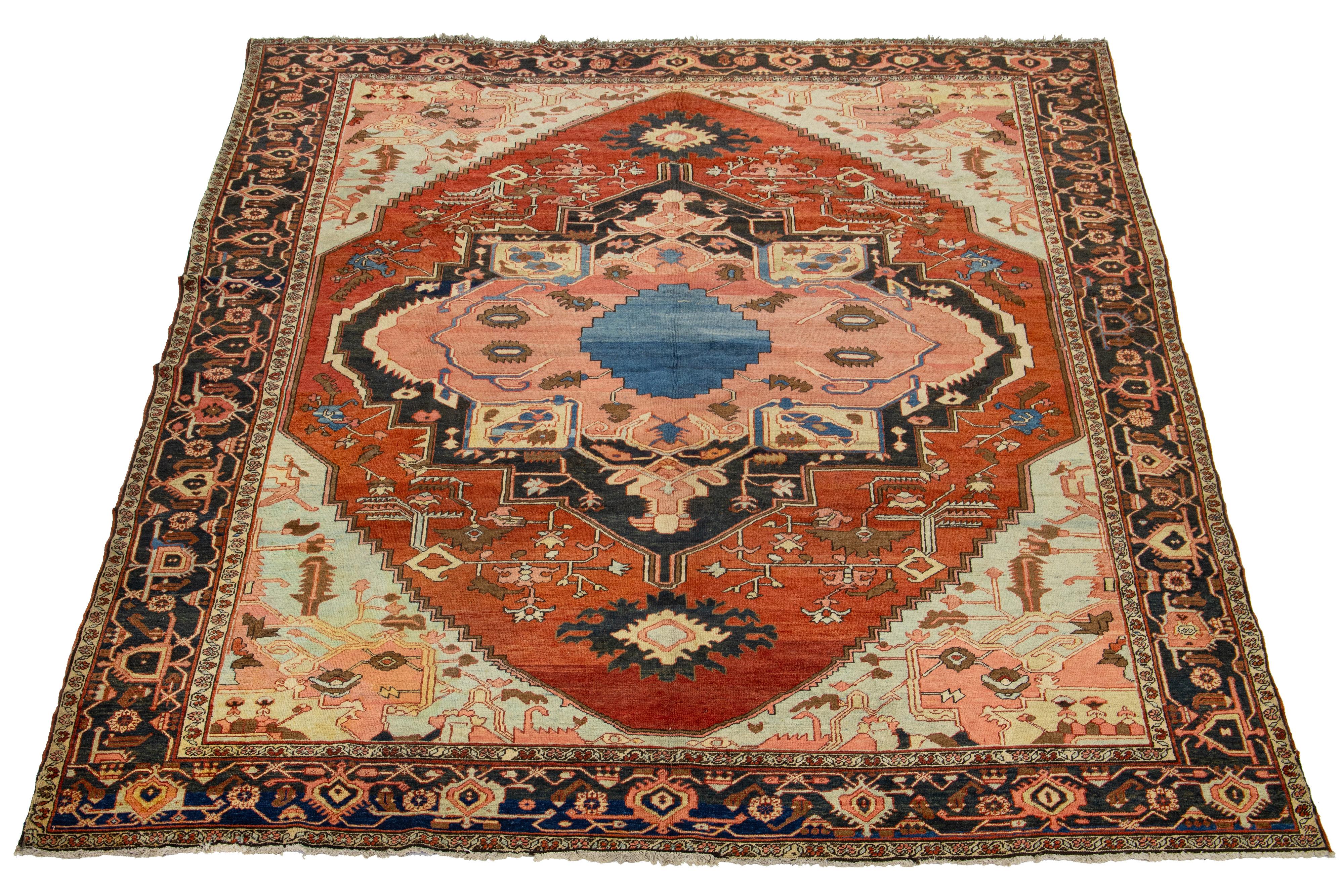 This antique Persian Serapi rug is made of hand-knotted wool. The rust field showcases a captivating medallion pattern adorned with multiple shades of colors.

This rug measures 9'2