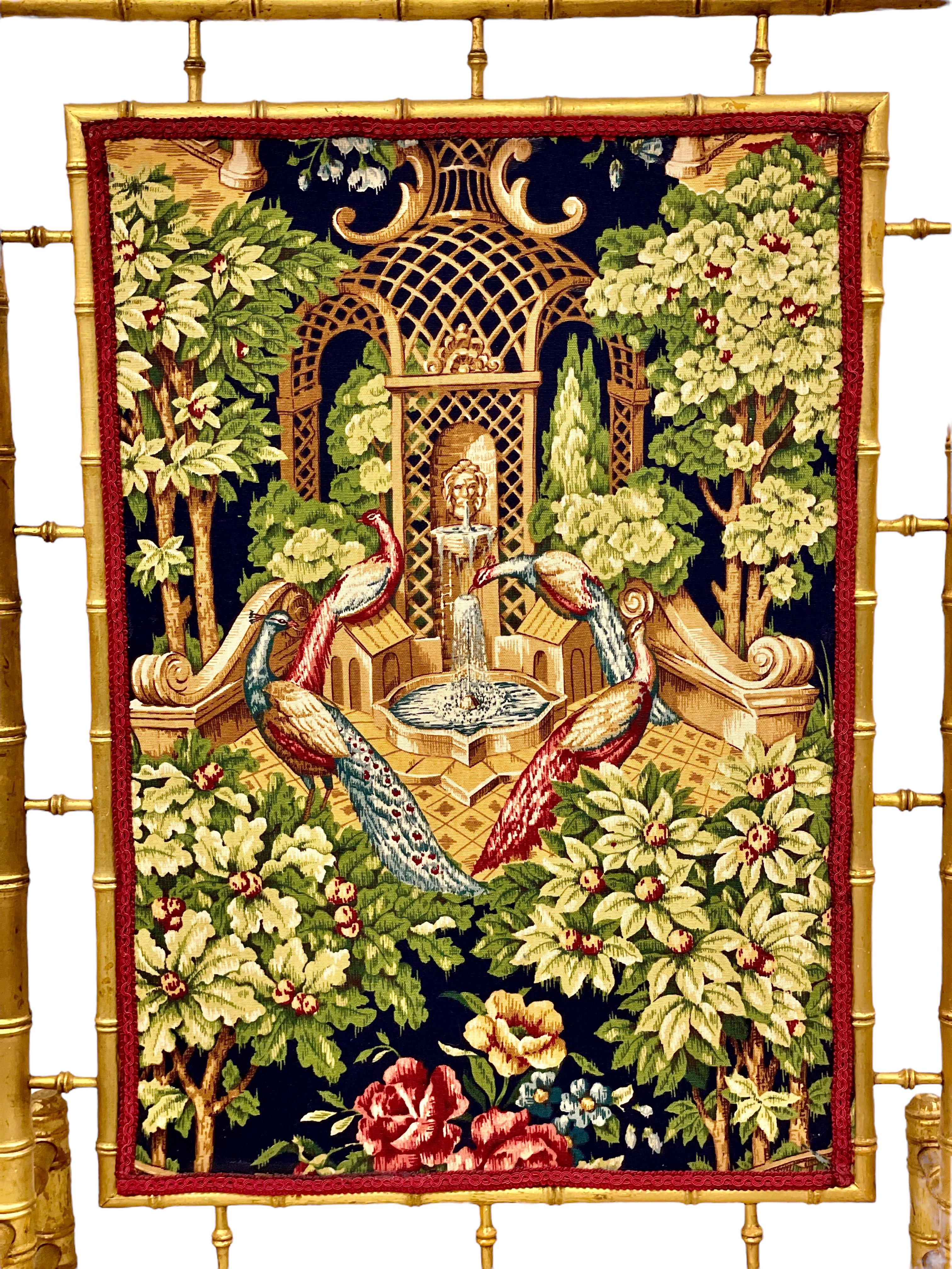 This superb faux-bamboo giltwood firescreen has been exquisitely crafted with a Japanese- inspired tapestry panel at its centre, which features a colourful design of peacocks assembling under an architectural pagoda, surrounded by lush tropical