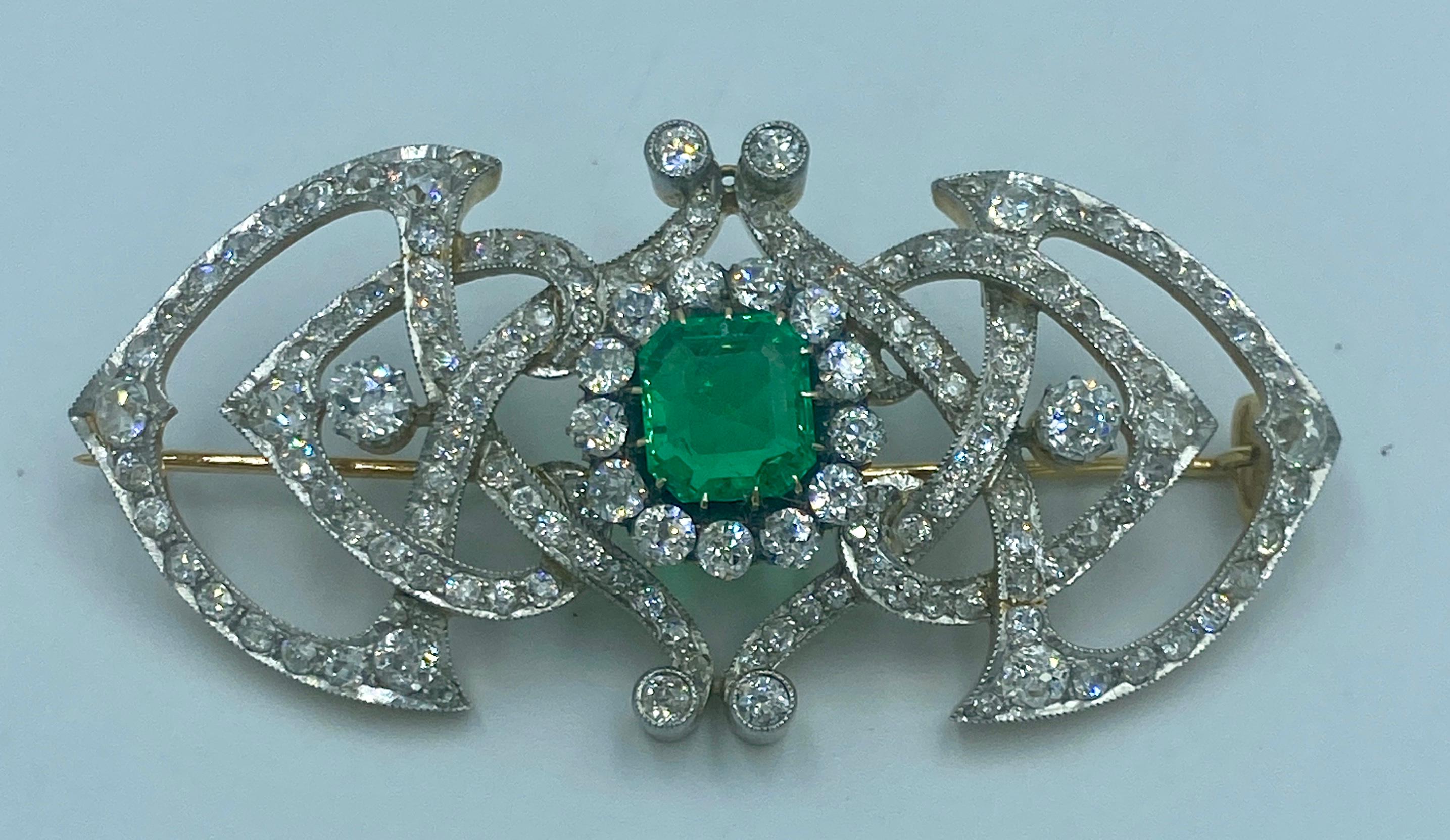 This classical French emerald and diamond brooch from circa 1870 consists of a vivid green square emerald cut emerald of approximately 5 carats adorned with 7 carats of old European cut diamonds. The stones have been set in platinum which is in turn