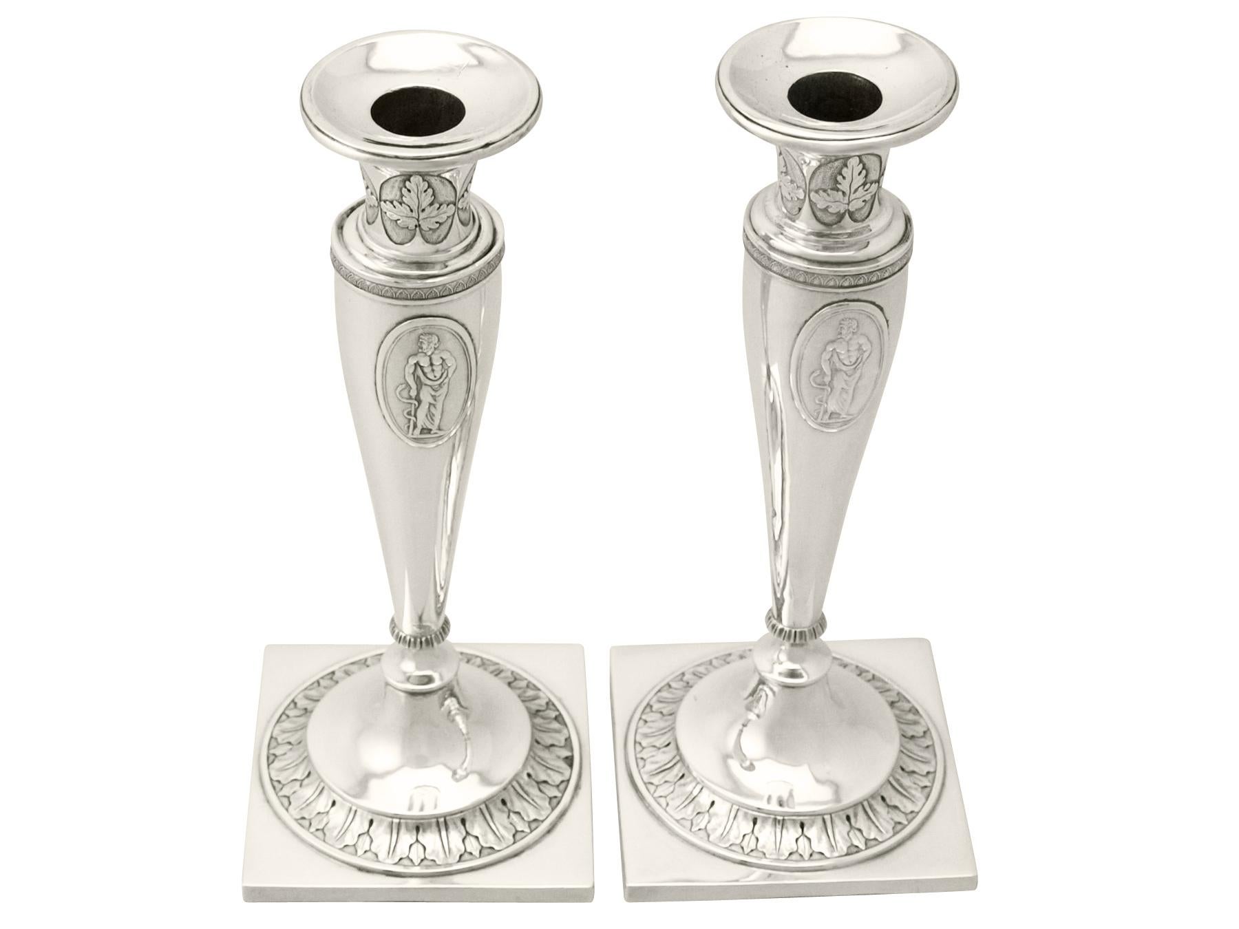 A very good pair of antique German silver candlesticks; an addition to our ornamental silverware collection.

These antique German silver candlesticks have a tapering, circular rounded form.

The candlesticks have waisted shaped capitals