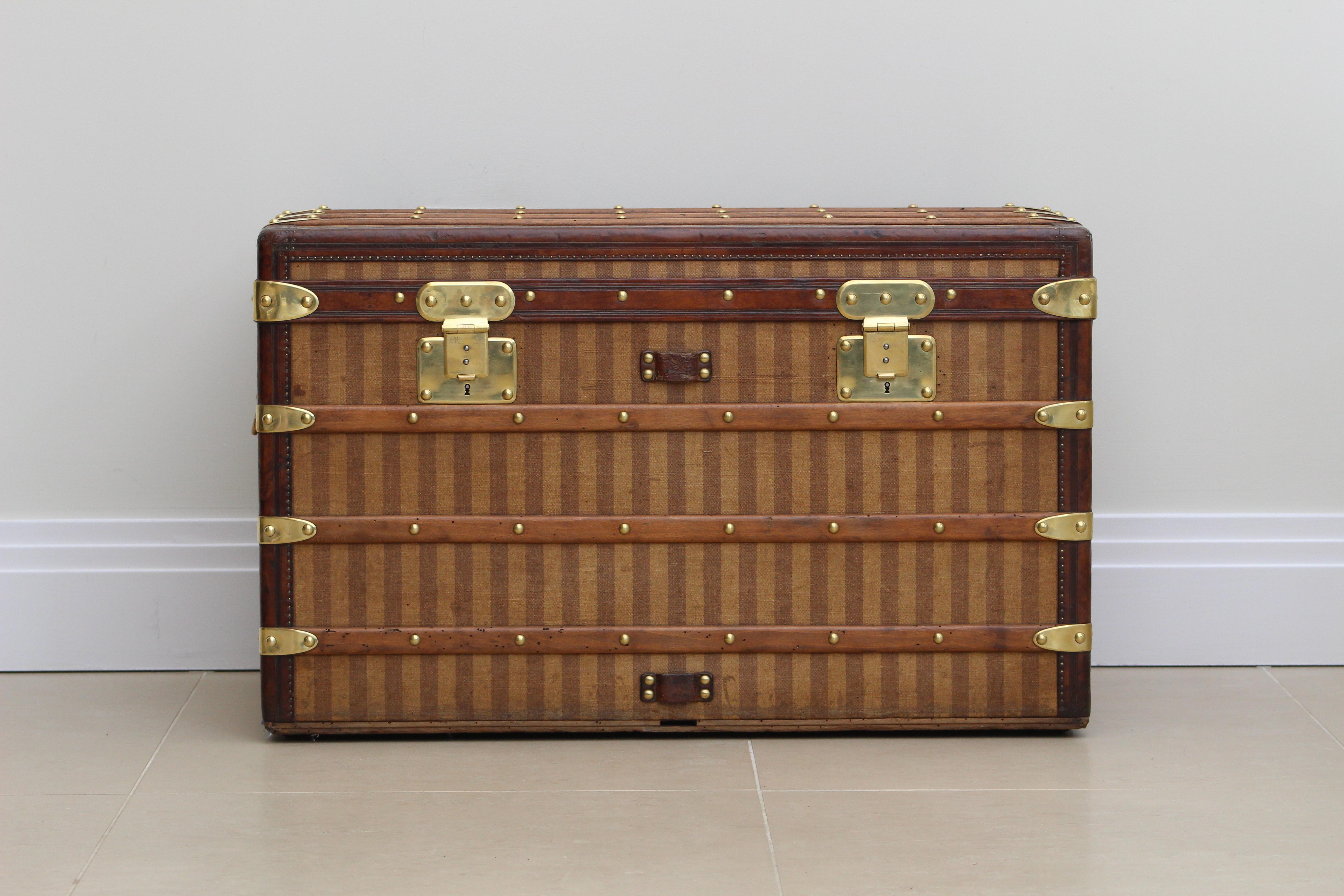 The Louis Vuitton Rayee Trunk from the 1870s stands as a paragon of elegance and timeless craftsmanship. At first glance, its exterior captivates with the iconic Rayee striped canvas, immediately hinting at the attention to detail and aesthetic