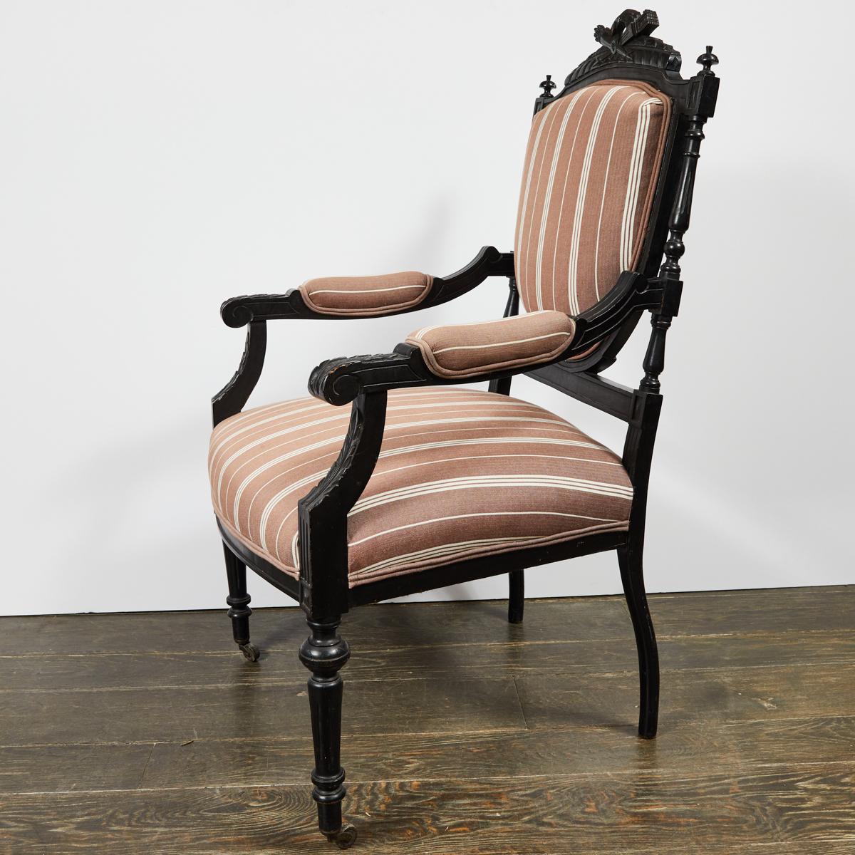 1870s Louis XVI style carved and ebonized fauteuil open armchair upholstered in custom taupe and cream striped linen. Mounted on casters, this armchair features beautifully carved neoclassical details.

France, circa 1870

Dimensions: 25W x 26D x 44H