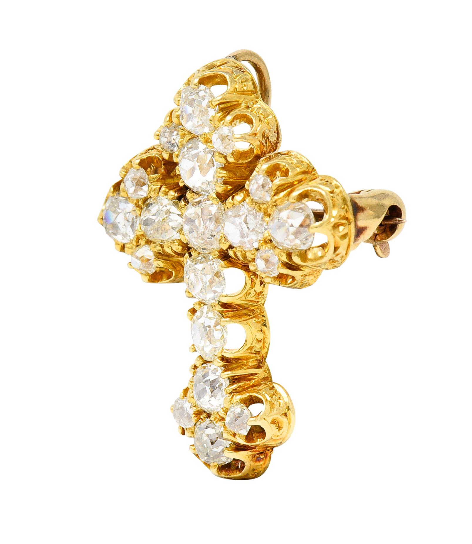Pendant brooch is designed as a cross with old mine cut diamonds belcher set throughout

Weighing in total approximately 2.00 carats with G to I color with overall SI clarity

Profile is hand-engraved with a scrolling whiplash design

Completed by a