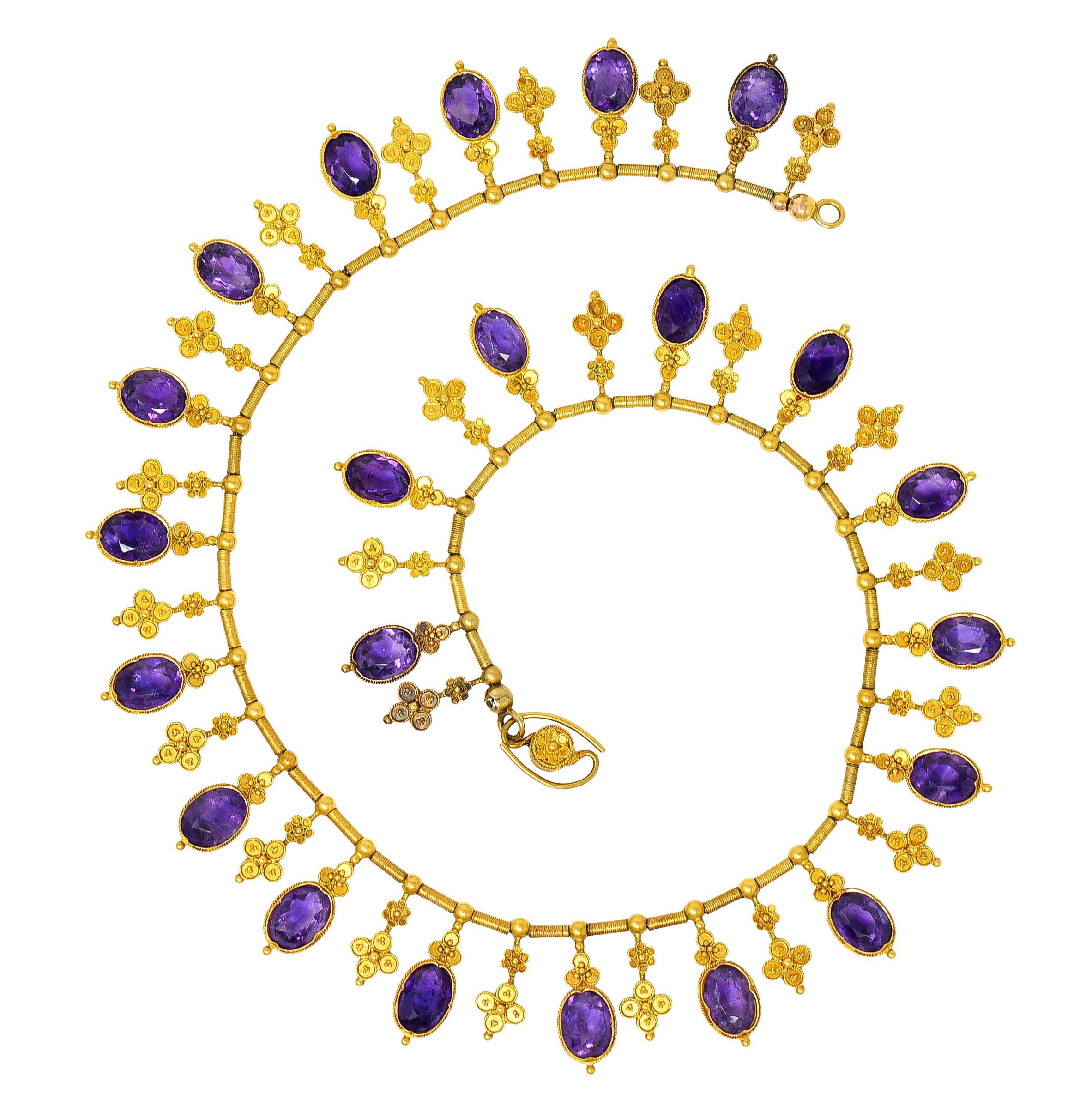 Braided chain necklace is strung with deeply ridged barrel links alternating with drops

Drops consist of bezel set amethysts topped by a clover motif alternating with floral quatrefoils

Amethysts are oval cut and slightly vary in size measuring