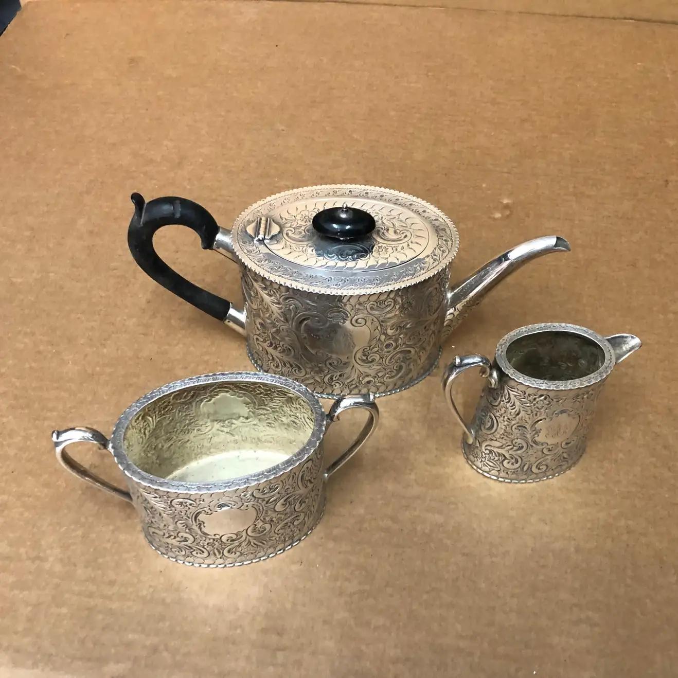 A rare three pieces tea set made in England in the second part of the 19th century. It's signed in the bottom Pearce Leeds & Huddersfield. Dimensions are of the tea pot.