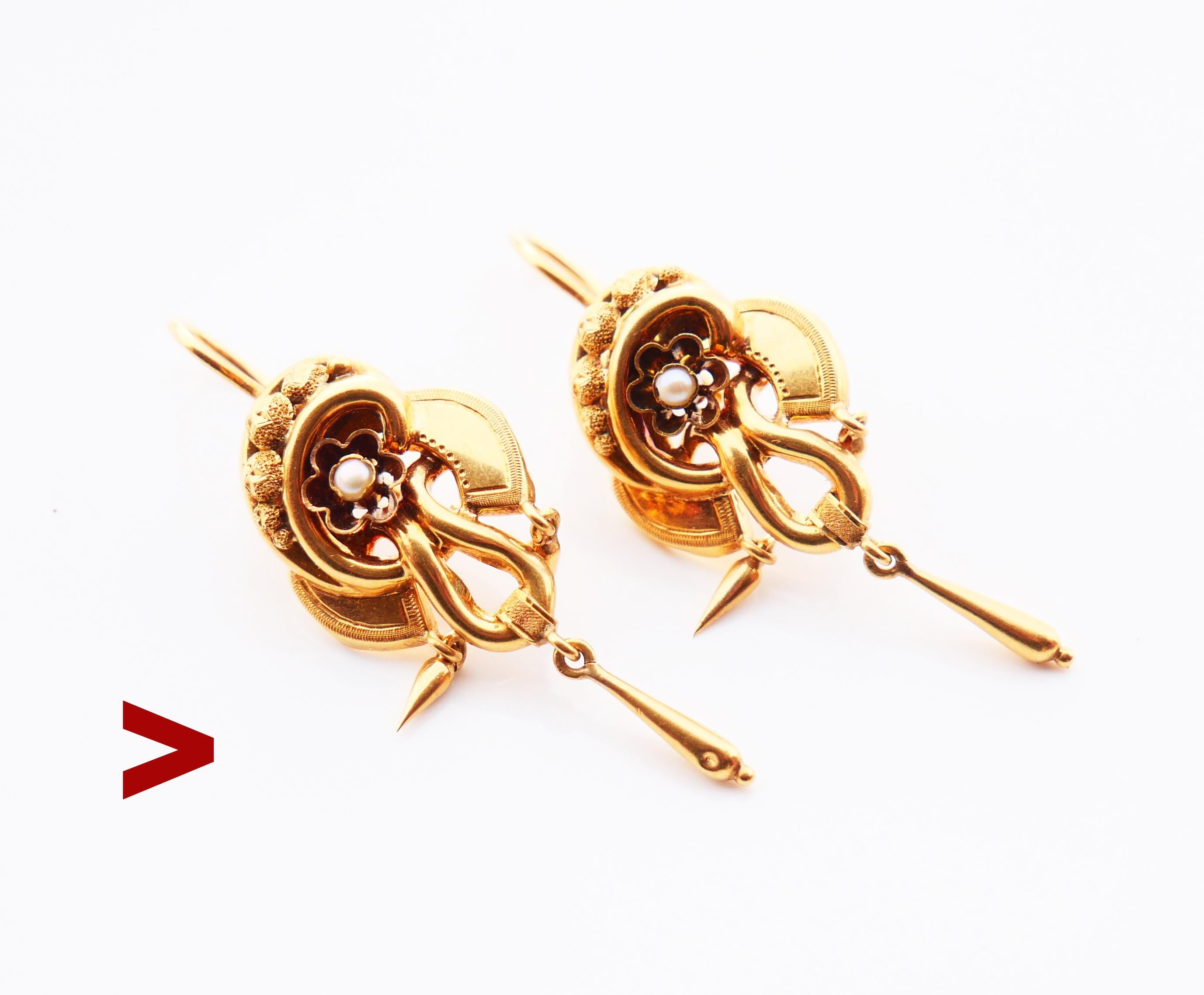 
A pair of antique earrings with delicate three-tier bodies decorated with natural seed pearls and engraved ornamentations.

Freely suspended drop-shaped dangles make this design complete.

Swedish hallmarks on both, marked 18K Gold, maker's GD&Co,