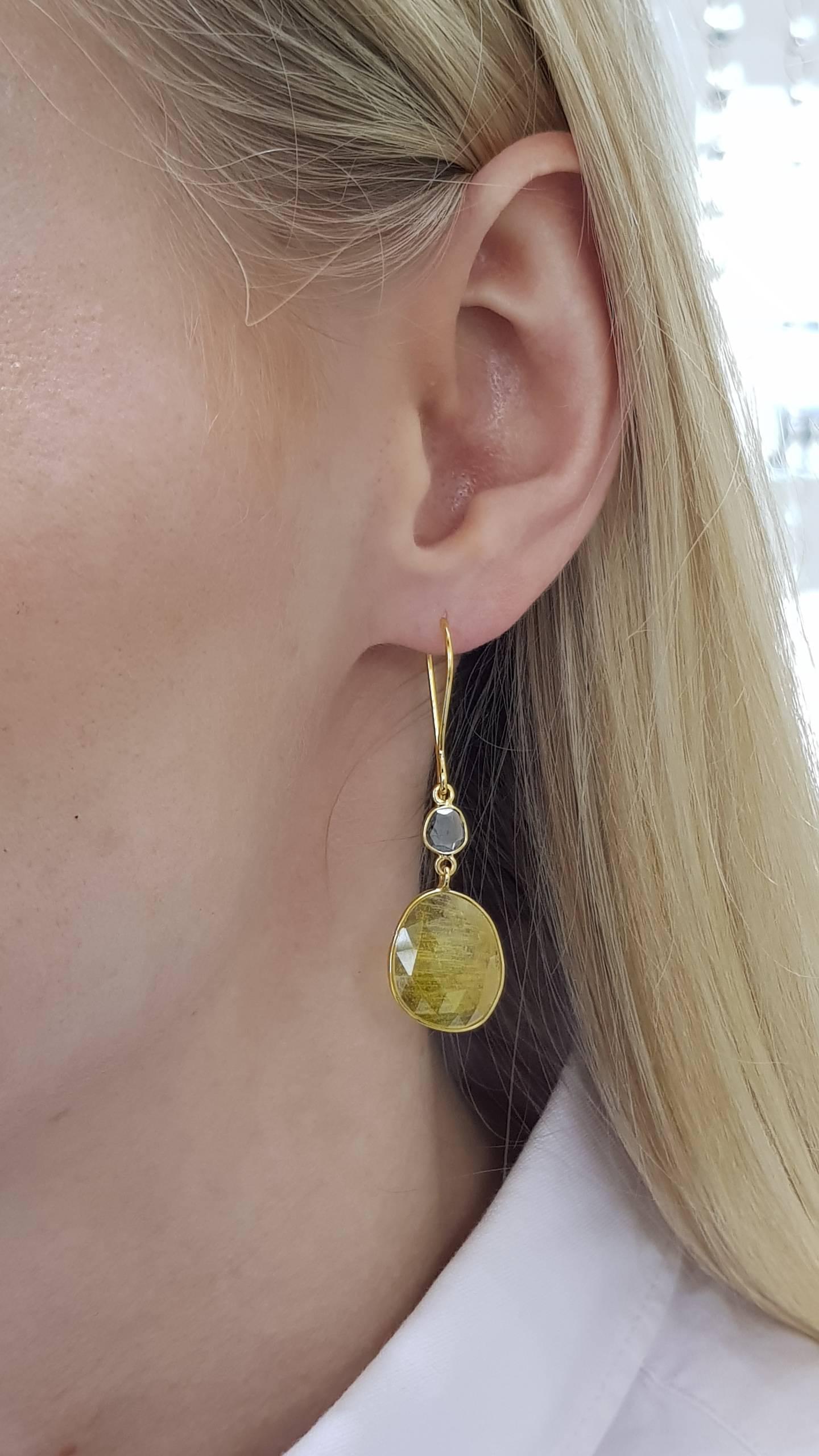 These Gorgeous 18.40 Carats Rose Cut Yellow Sapphire Earrings feature 0.32 Carat in two Diamond slices set in 18 Karat Yellow Gold. Each piece is hand made with a unique shaped precious stones. These elegant and lightweight earrings are perfect for