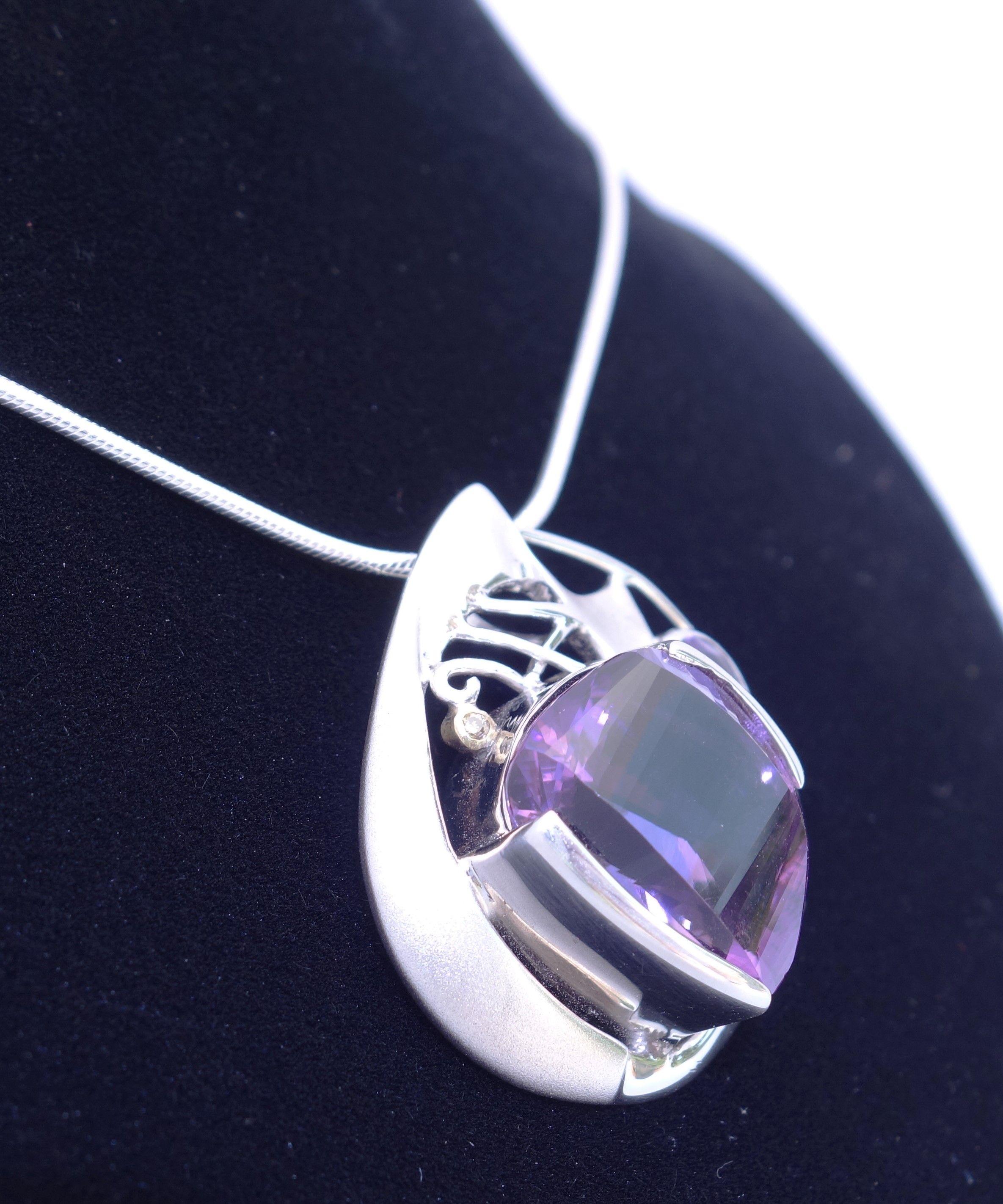 Simply Beautiful! Amethyst and Diamond Gold and Sterling Silver Pendant Necklace. Centering a Fancy cut Amethyst, weighing approx. 18.74 Carats, measuring: 20.5mm x 15mm and 8mm x 6mm. Accented by an Oval Amethyst, weighing approx. 2.04 Carats and 3
