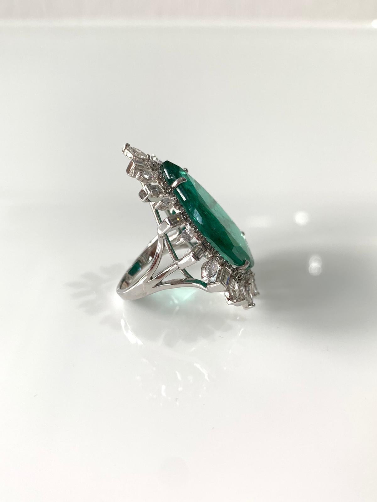 A gorgeous cocktail ring set in 18k white gold with natural pear cut emerald and natural diamond. The emerald is natural from Zambia and weight is 18.74 carats, diamond is natural and weight is 2.73 carats. The net gold weight is 10.56 grams and