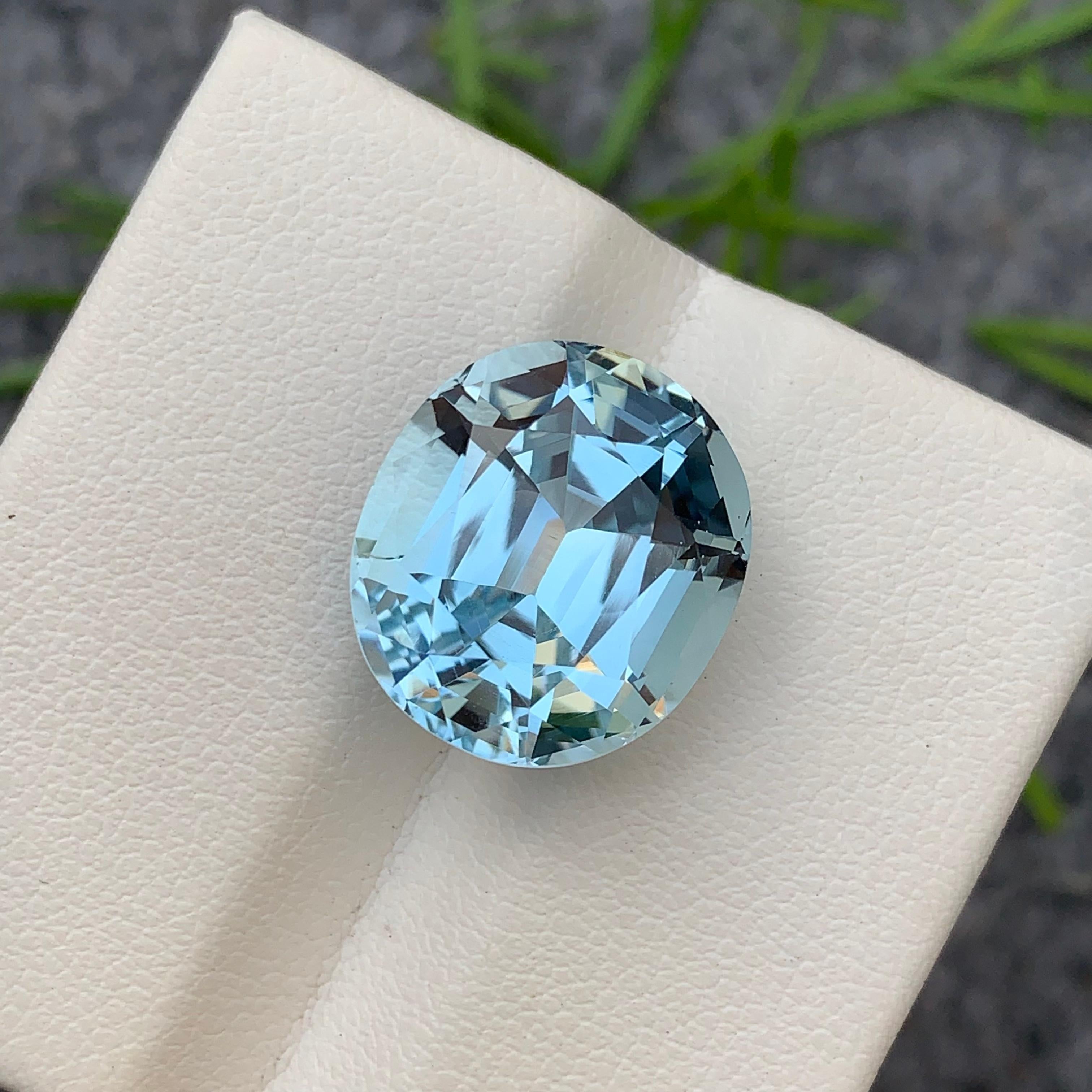Faceted Light Blue Topaz 
Weight: 18.75 Carats 
Dimension: 16.1x14.4x10.8 Mm
Origin: Brazil 
Color: Light Blue 
Shape: Cushion 
Certificate: On Demand 
.
Blue topaz is a mesmerizing gemstone that showcases a captivating blue hue reminiscent of clear