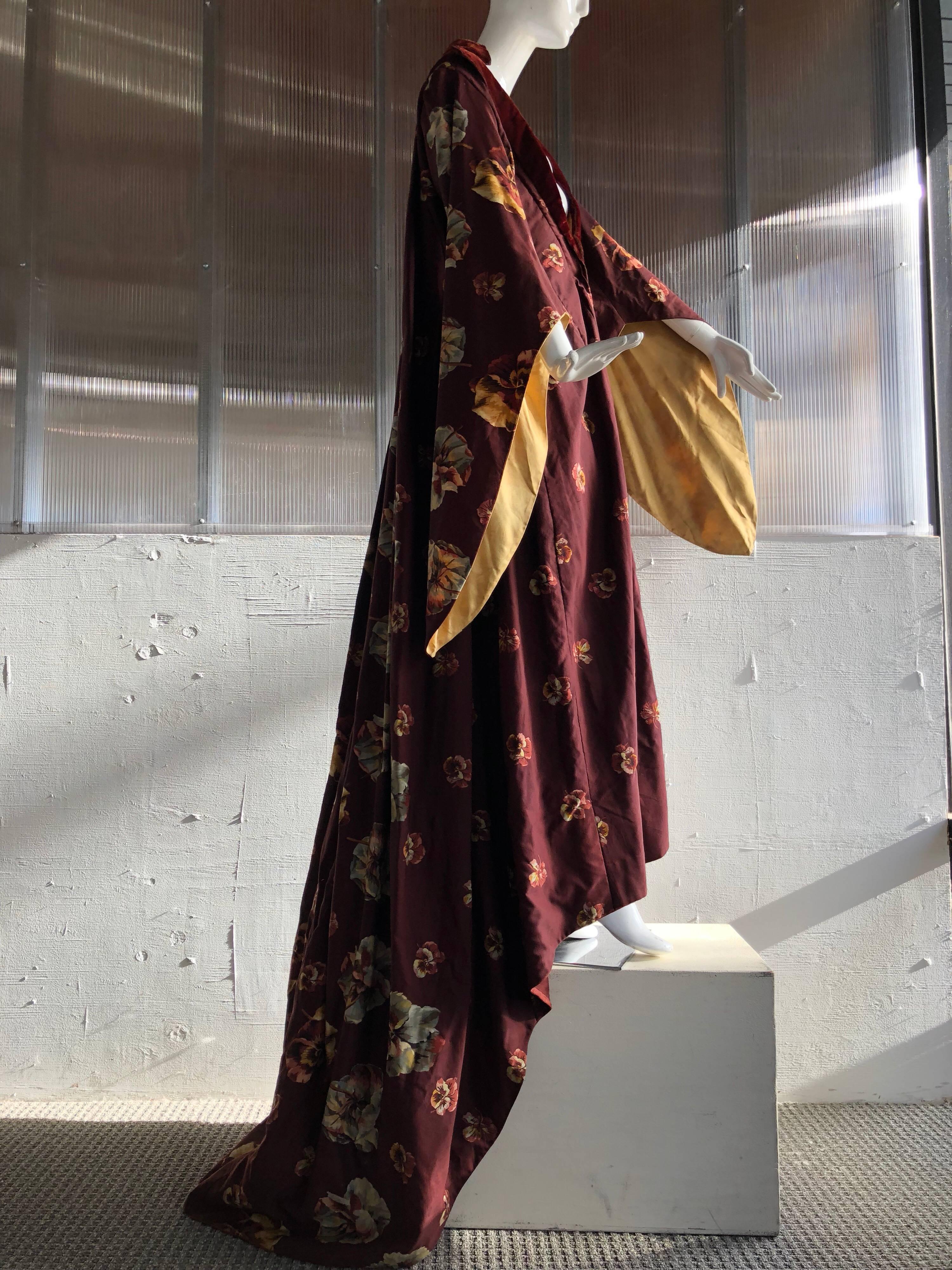 This garment from 1875 features dramatic sleeve and Watteau-back robe déshabillé with train in a gorgeous Victorian floral printed wool challis. Plunging velvet-trimmed neckline. Stunning design and in beautiful condition for its age. 