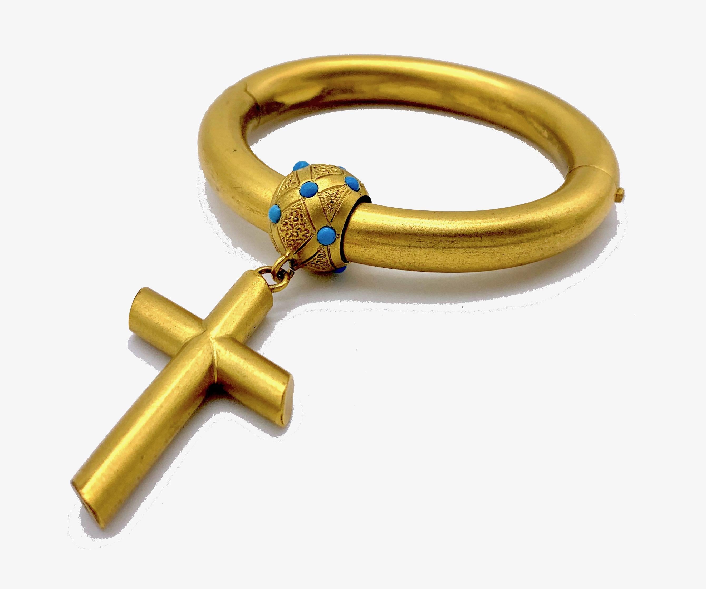 Stylish and unusual High Victorian fire gilt hinged bangle with a large removable cross.
The cross is suspended from a large finely engraved ball shaped ring and can be worn separately on a chain or a ribbon. 
The measurements of width and depth are