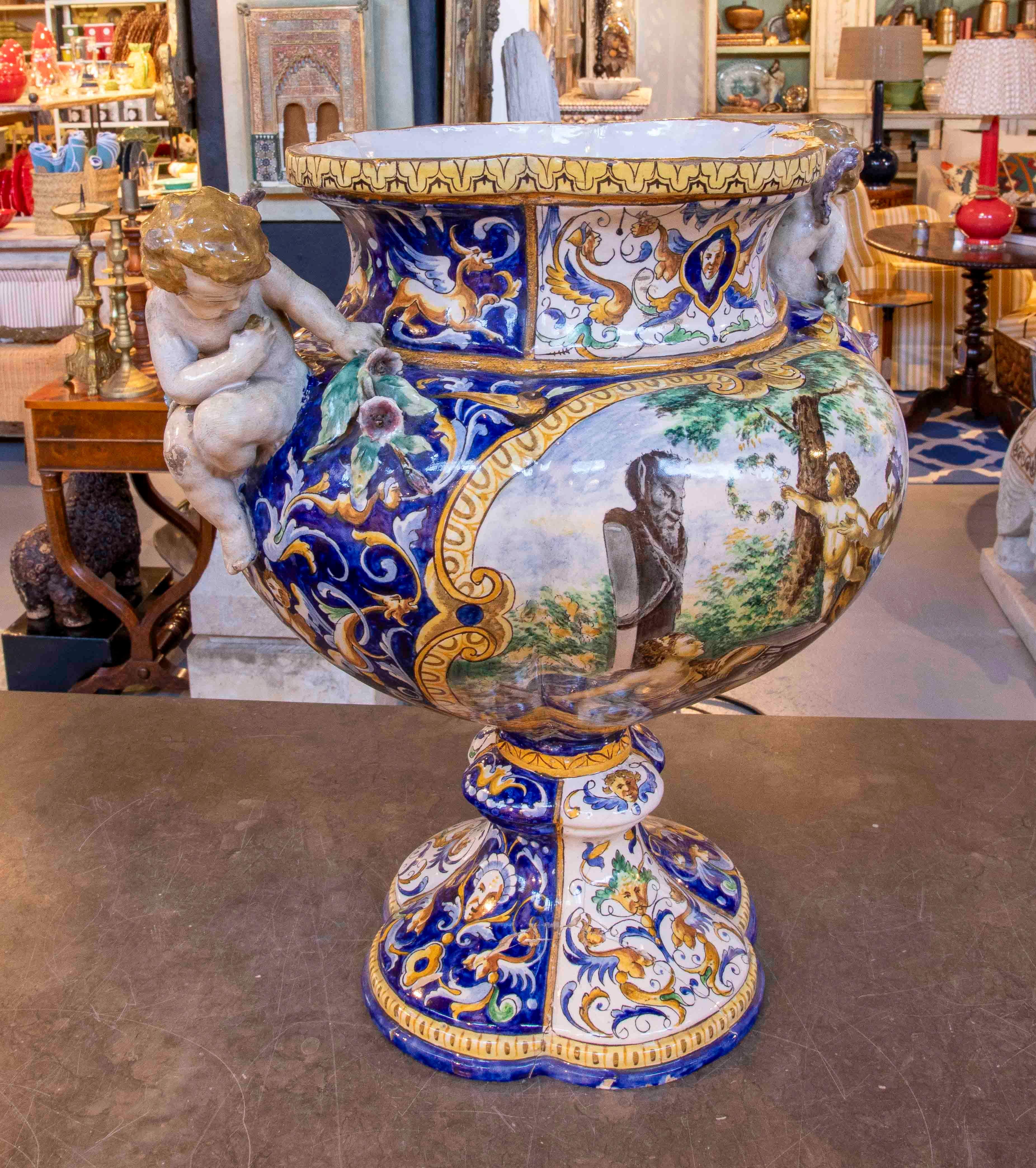 Magnificent, richly decorated Italian majolica vase, signed on the base by Gi. Battojin, a distinguished master ceramist. The piece features hand-painted mythological scenes in vivid colors, framed by Baroque ornamental motifs in blue, gold, and
