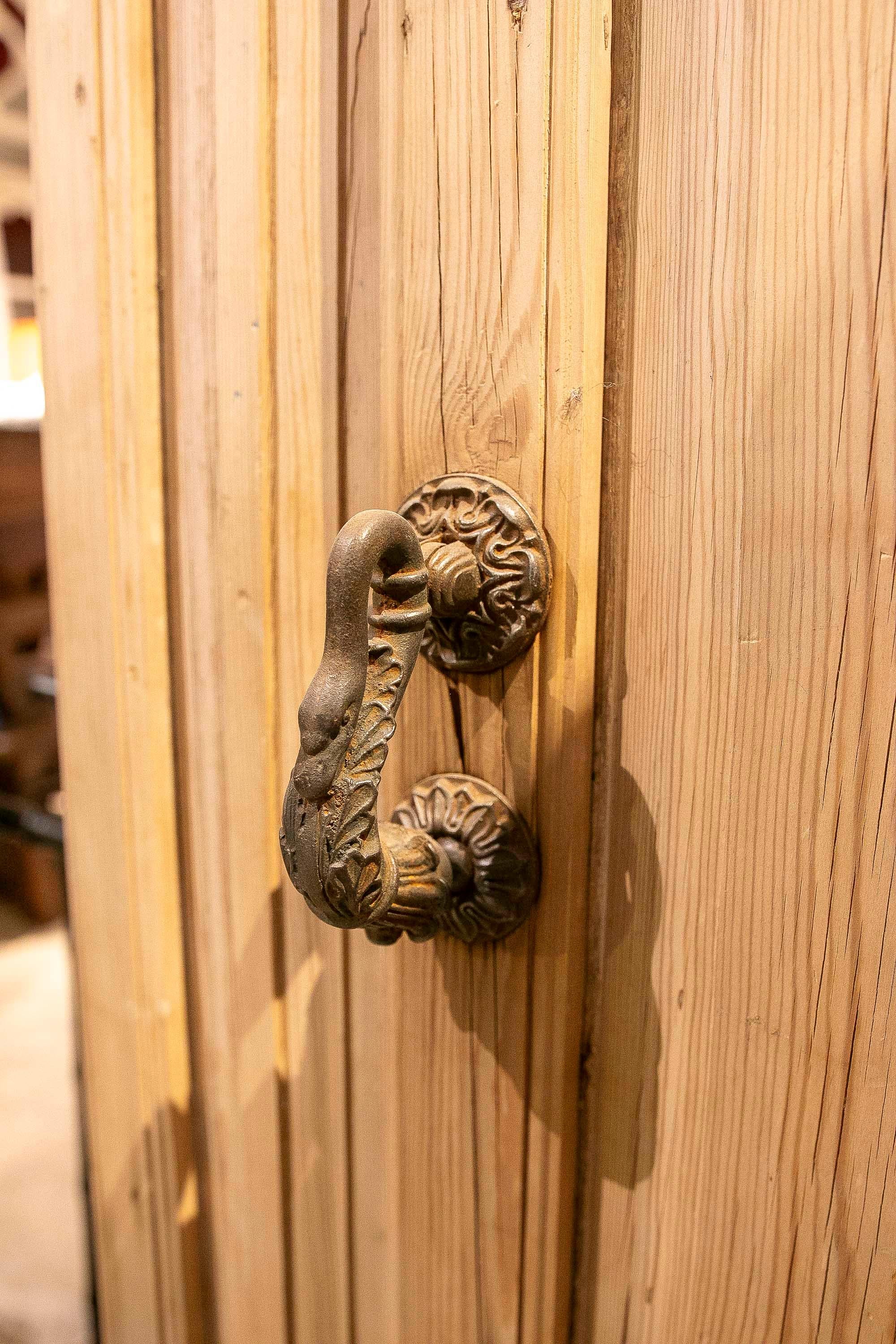 An elegant pair of antique doors crafted from solid wood, retaining their original structure of carved panels in varying shapes and proportions. Their natural finish highlights the wood grain and character, adding warmth and authenticity.
They