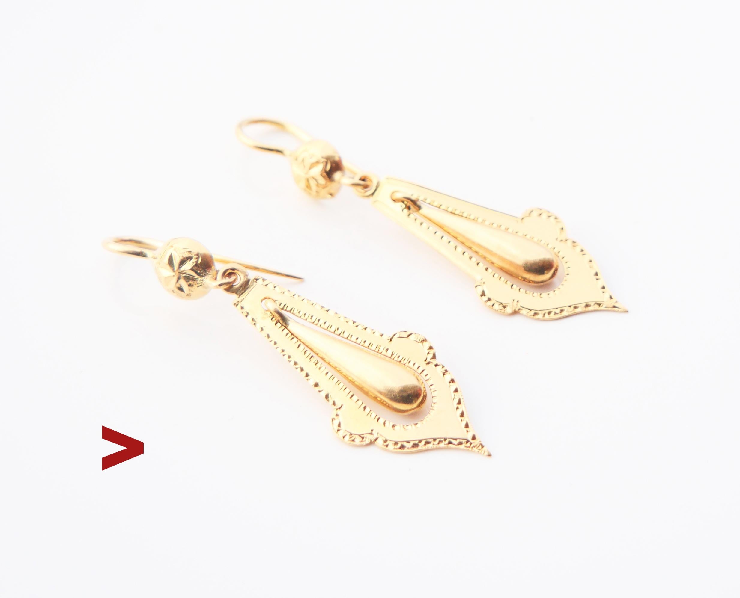 A pair of antique Viking Revival styled earrings with drop-shaped hollow pendants freely suspended within leaf - shaped frames decorated with  delicate hand- engraved ornaments on frontal sides.

Swedish hallmarks on both marked 18K Gold.

Maker's