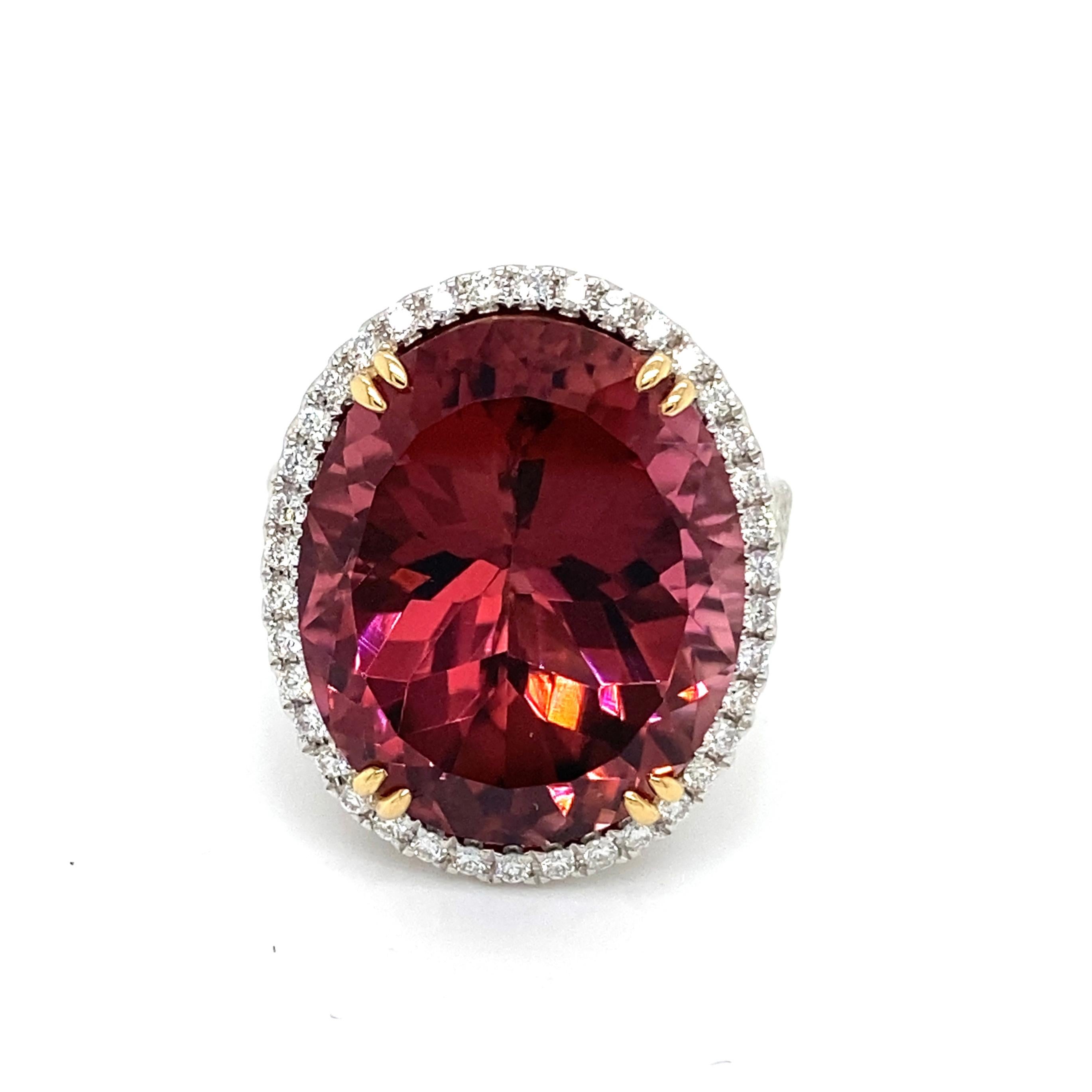 This stunning cocktail ring showcases a beautiful 18.79 Carat Oval Rubellite Tourmaline with a Diamond Halo on a Double Diamond Shank. This ring is set in 18k white gold, with 18k yellow gold prongs on the center stone.
Total Diamond Weight = 0.83