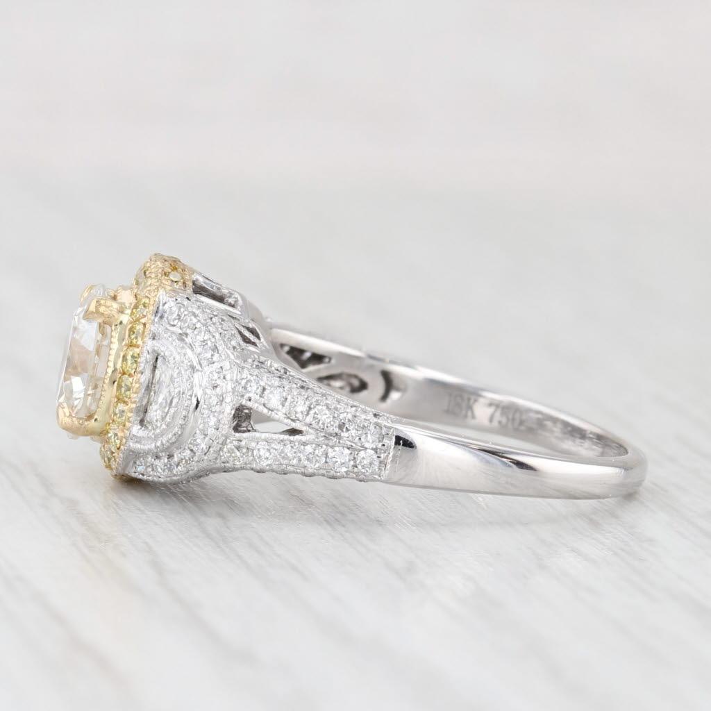 Questo bellissimo anello è incastonato con un solitario di diamanti rotondi incorniciato da un'aureola di diamanti gialli fantasia per un tocco di colore che cattura l'attenzione. I diamanti con taglio a mezza luna accentuano i lati del centro,