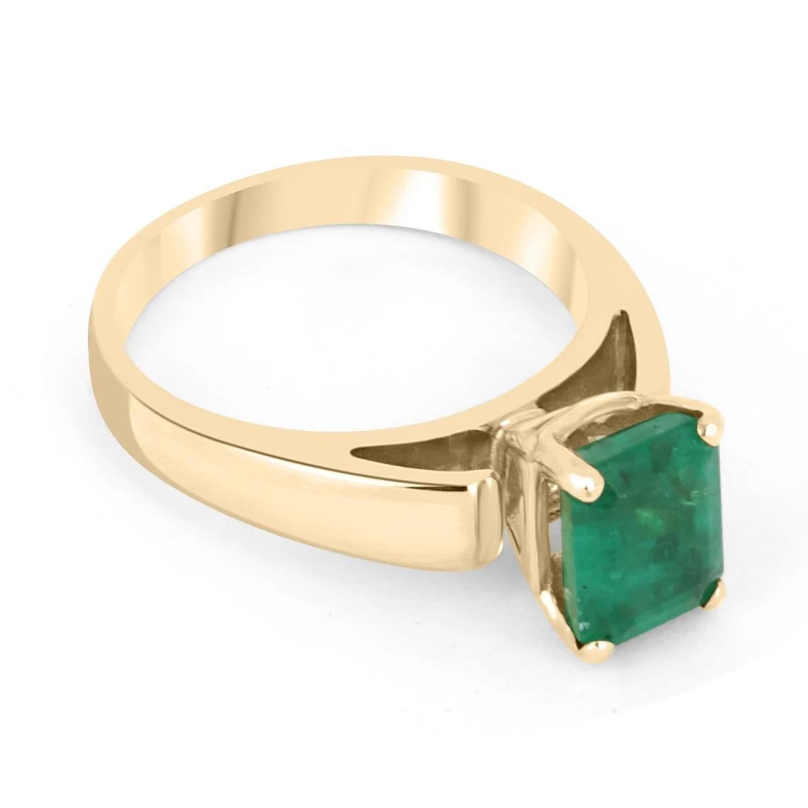 Displayed is a classic Colombian emerald solitaire emerald-cut engagement or right-hand ring in 18K yellow gold. This gorgeous solitaire ring carries a full 1.88-carat emerald in a four-prong setting. Fully faceted, this gemstone showcases excellent