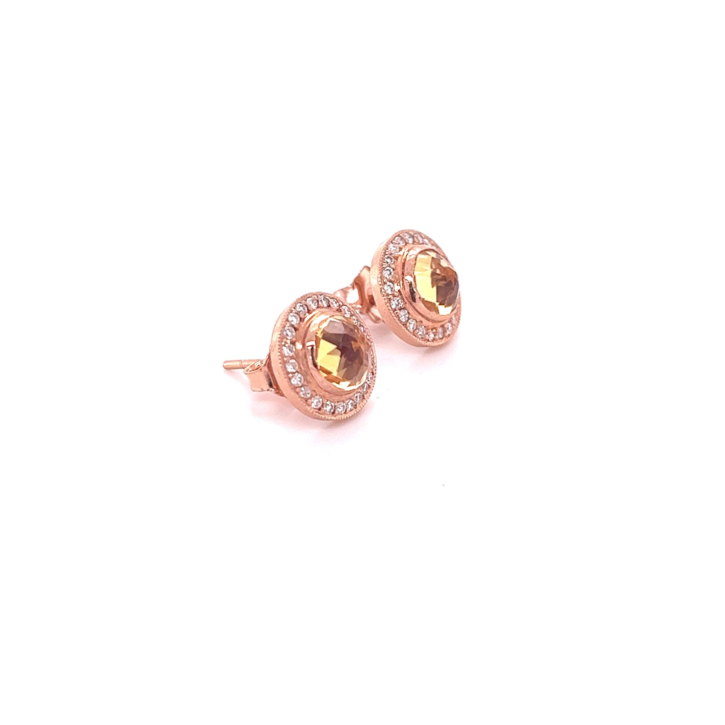 These earrings have Natural Citrines that weigh 1.58 carats and also Natural Round Cut Diamonds that weigh 0.30 carats. The total carat weight of the earrings are 1.88 carats. 

Curated in 14 Karat Rose Gold and have an approximate weight of 2.7