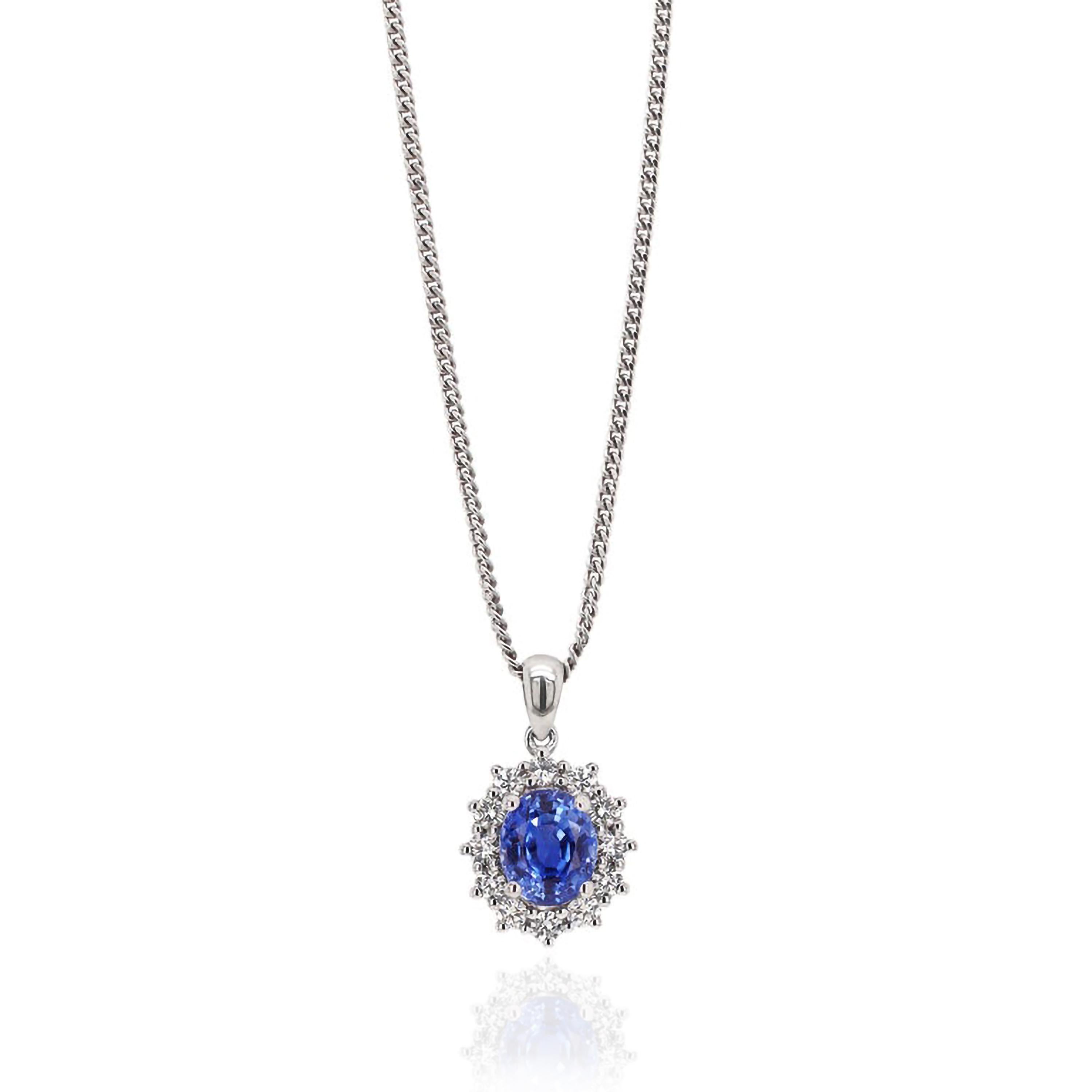 Pendant featuring a 1.88ct vibrant oval blue sapphire set in a four claw open back setting. The beautiful sapphire is surrounded by 12 fine quality round brilliant cut diamonds weighing a total of 0.39ct all claw set in 18ct white gold.