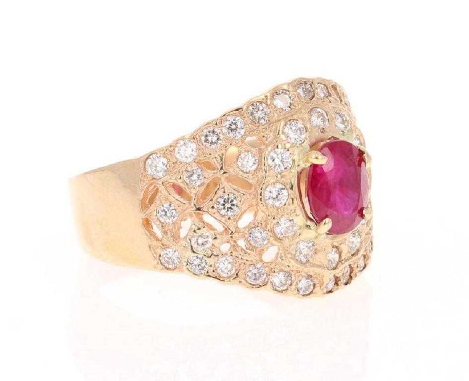 The Oval Cut Ruby is 1.07 carats and is surrounded by 50 Round Cut Diamonds that weigh 0.81 carats (Clarity: VS2, Color: H).  
The ruby measures at 7 mm x 6 mm and the entire face of the ring is 19 mm x 16 mm. 
The ring is casted in 14K Yellow Gold