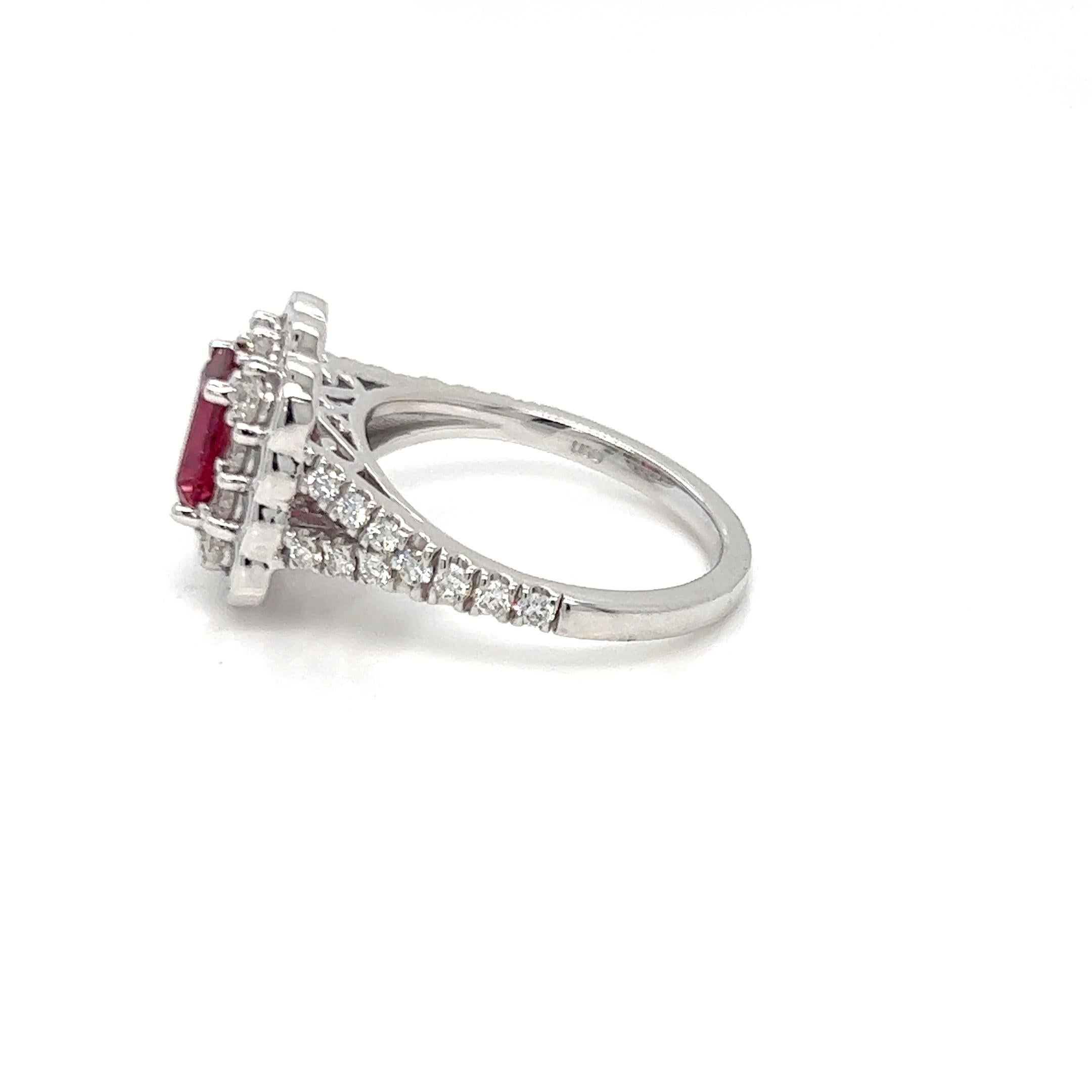 Presenting our magnificent 1.88 Carat Emerald Cut Ruby Diamond Halo Engagement Ring, which showcases a magnificent Mozambique ruby encircled by a dazzling halo of diamonds. This exquisitely designed ring is a timeless representation of love and