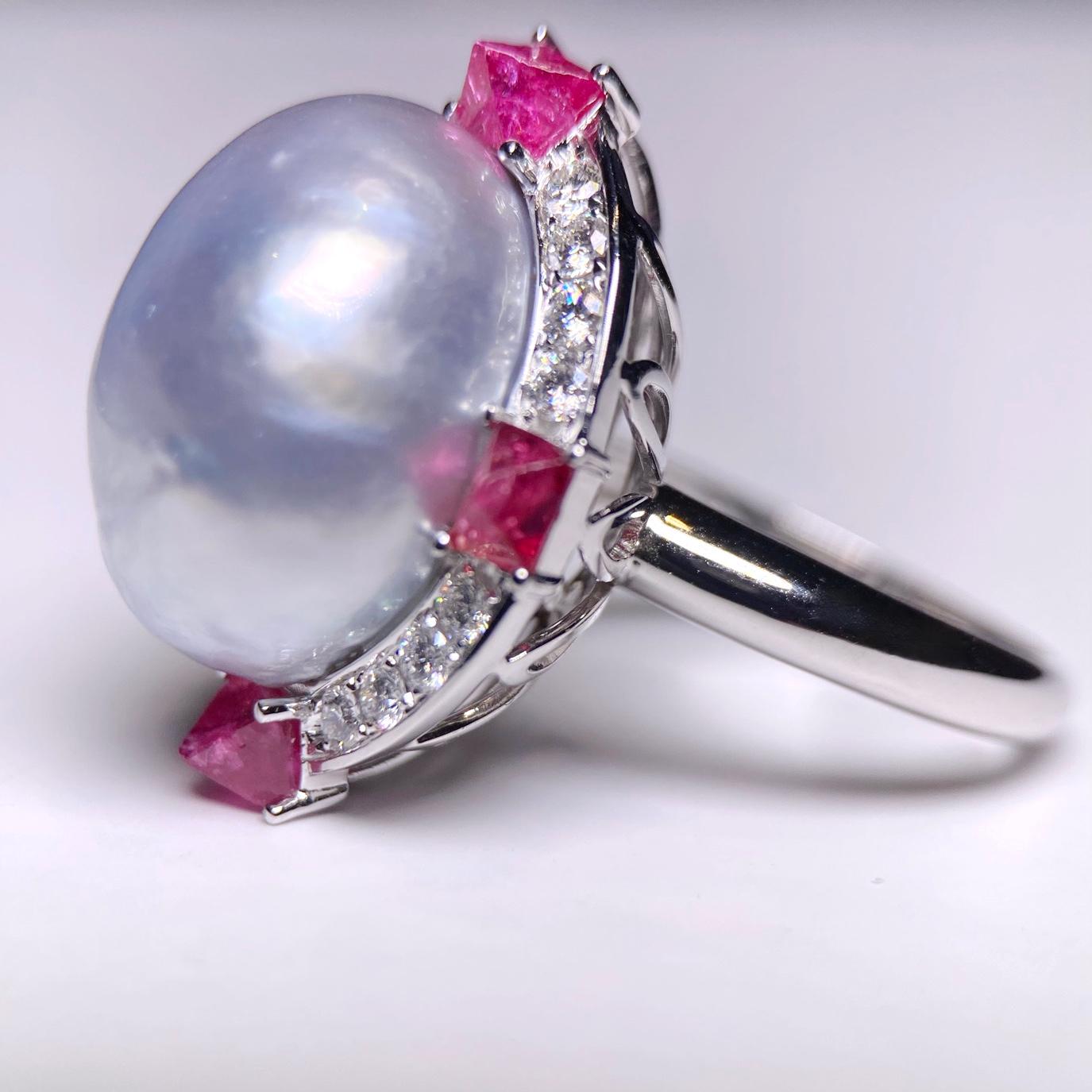 A big statement cocktail ring with Baroque South Sea Pearl, Red Spinel and Diamond Ring in 18K White Gold. The Oval shape pearl is surrounded by  diamond pave and 4 rough cut Red Spinel. Every thing about this ring screams personality, The pearl is