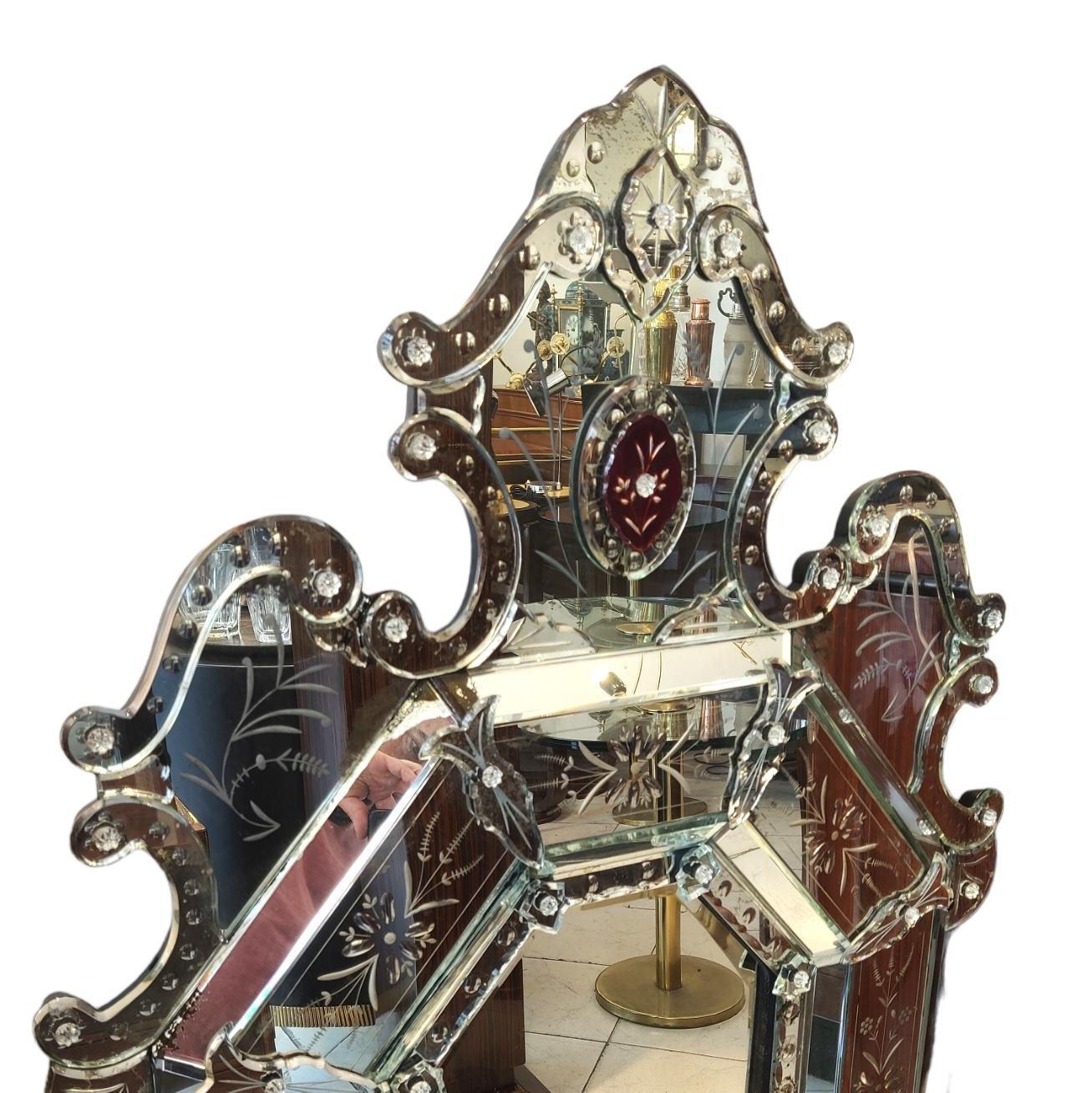 Impressive wall mirror, black painted wooden frame covered with hand-cut and hand-polished crystals. With that unique aspect of Venetian mirrors.