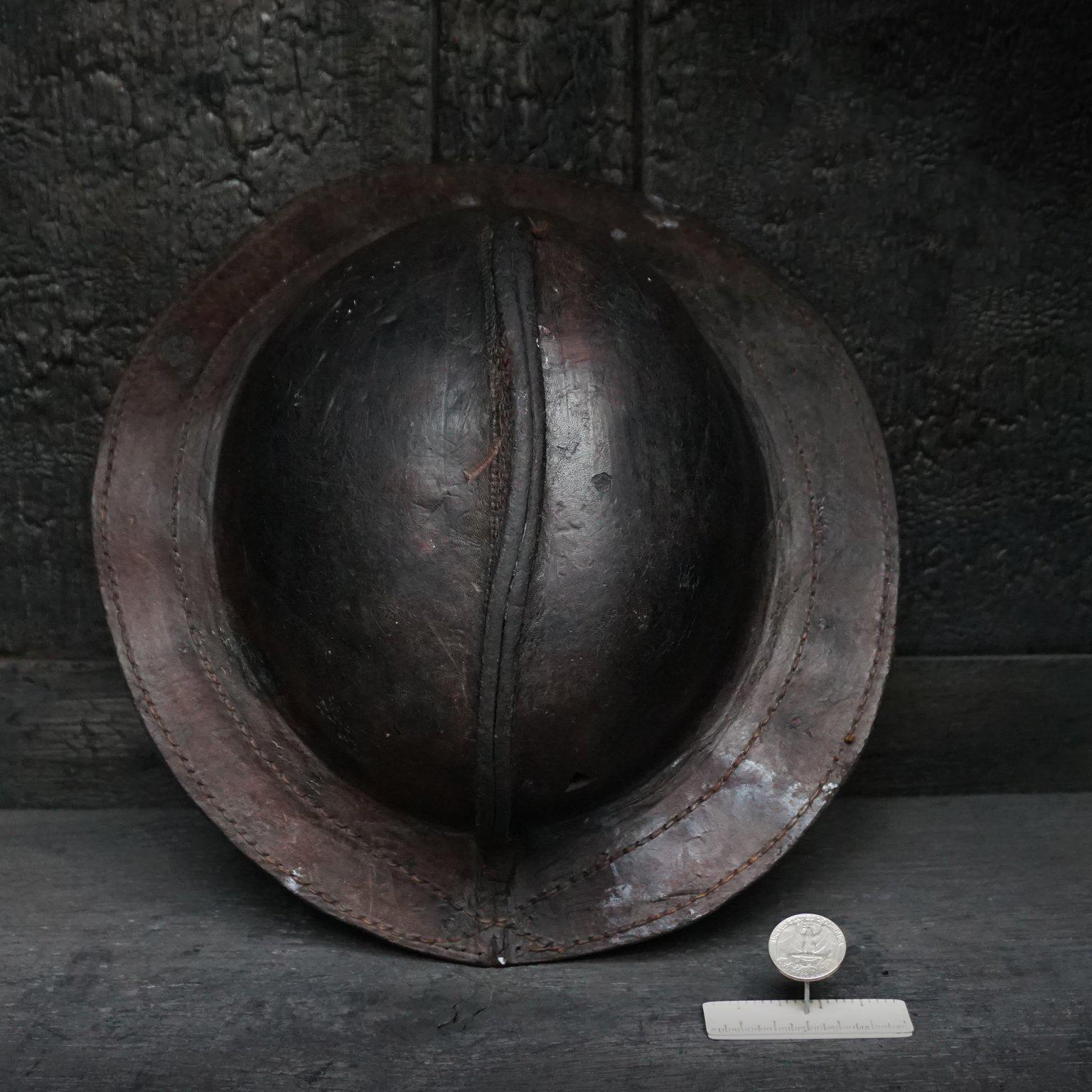 This early miners hat was made from leather. They used to make it wet before putting the hat on and going into the mine. First of all to correct the fit of the hat and secondly because of the high temperatures down below. The triangular holes were