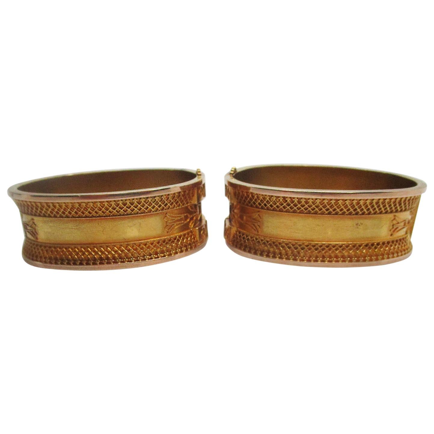 This is an incredible set of two matching 14k yellow gold Etruscan hinged bangles with gorgeous milgrain and filigree details! The bangles are in near mint condition and in their original box!! These bangles are wide and bold. The dramatic design