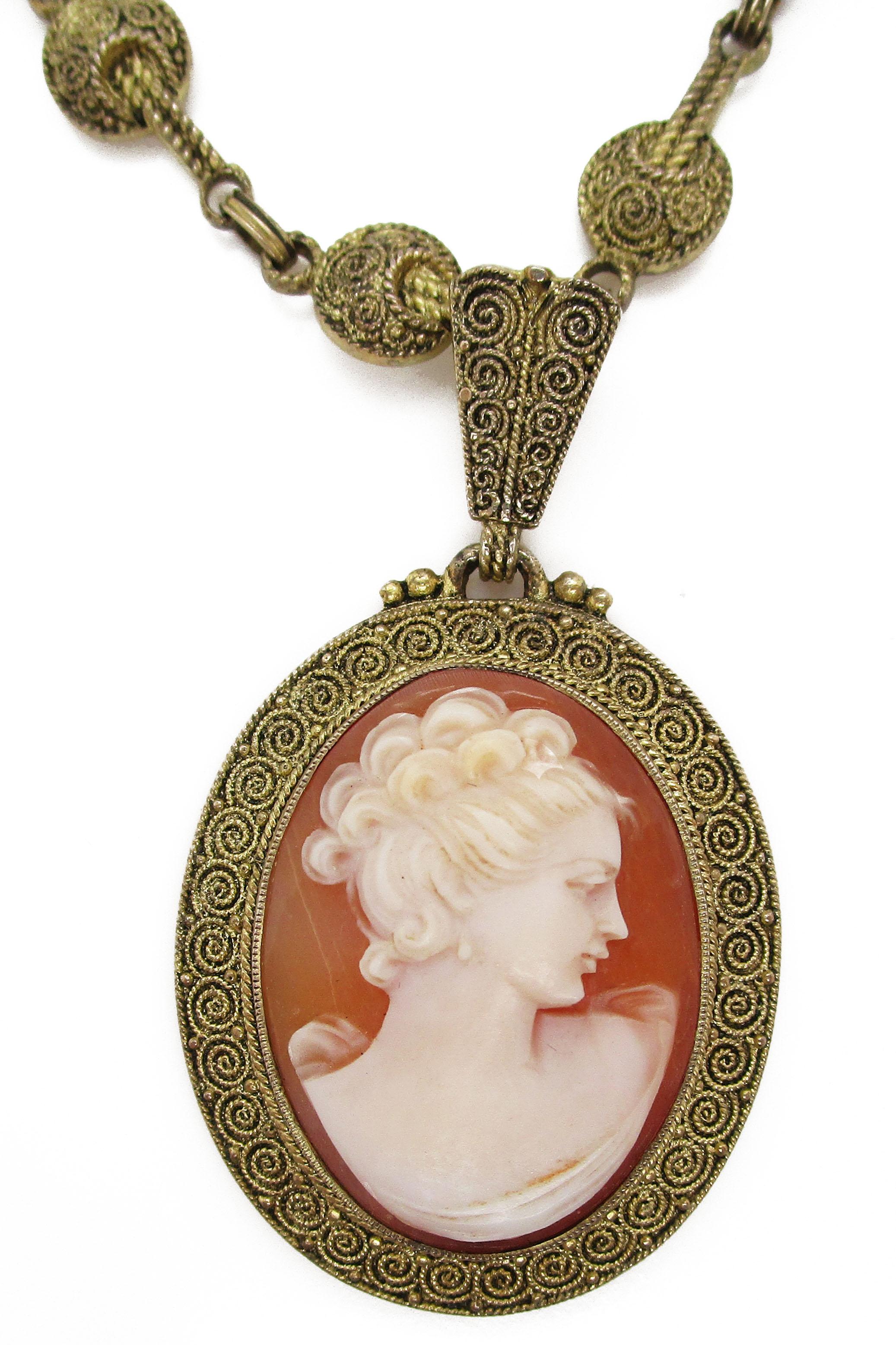 This is a magnificent shell cameo pendant and necklace with an enchanting gold vermeil sterling silver chain that dates back to the early 1900's and is signed Theodor Fahrner! Both the chain and the cameo pendant are signed with the classic TF
