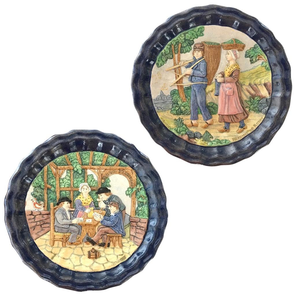 Two quite rare earthenware sculptural decorative plates in barbotine, dated 1880, handcrafted in Clermont Ferrand, central part of France, by Charles Jaubert decorator, engraved signature at the back and front of each dish, substantially framed by a