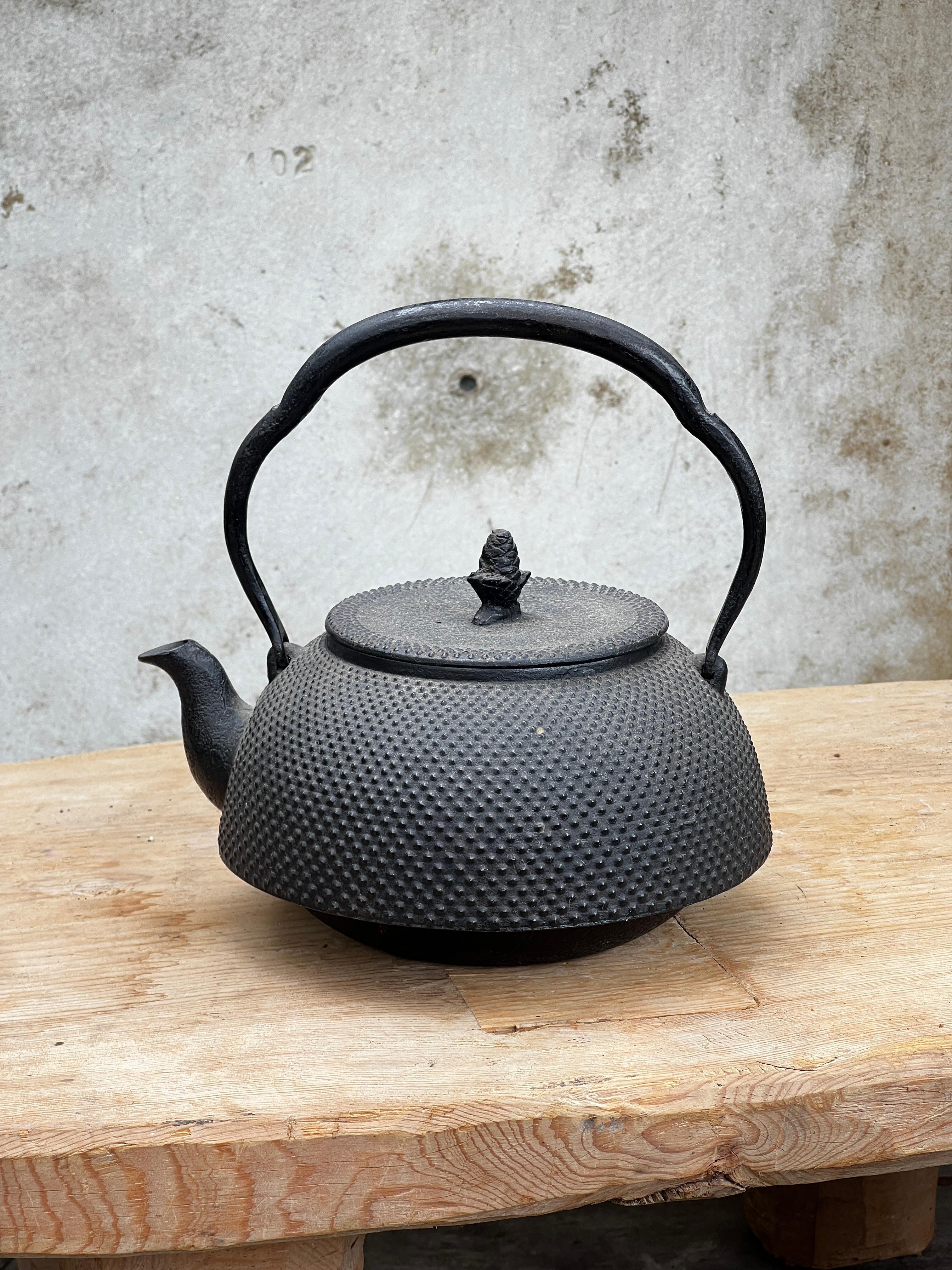 Adorned with a Textured Surface and a Gracefully Arched Handle, This Japanese Teapot Served the Purpose of Boiling Water for Customary Tea Ceremonies. Identified as a Tetsubin, Its Cast-Iron Composition is Believed to Enhance Water Quality,