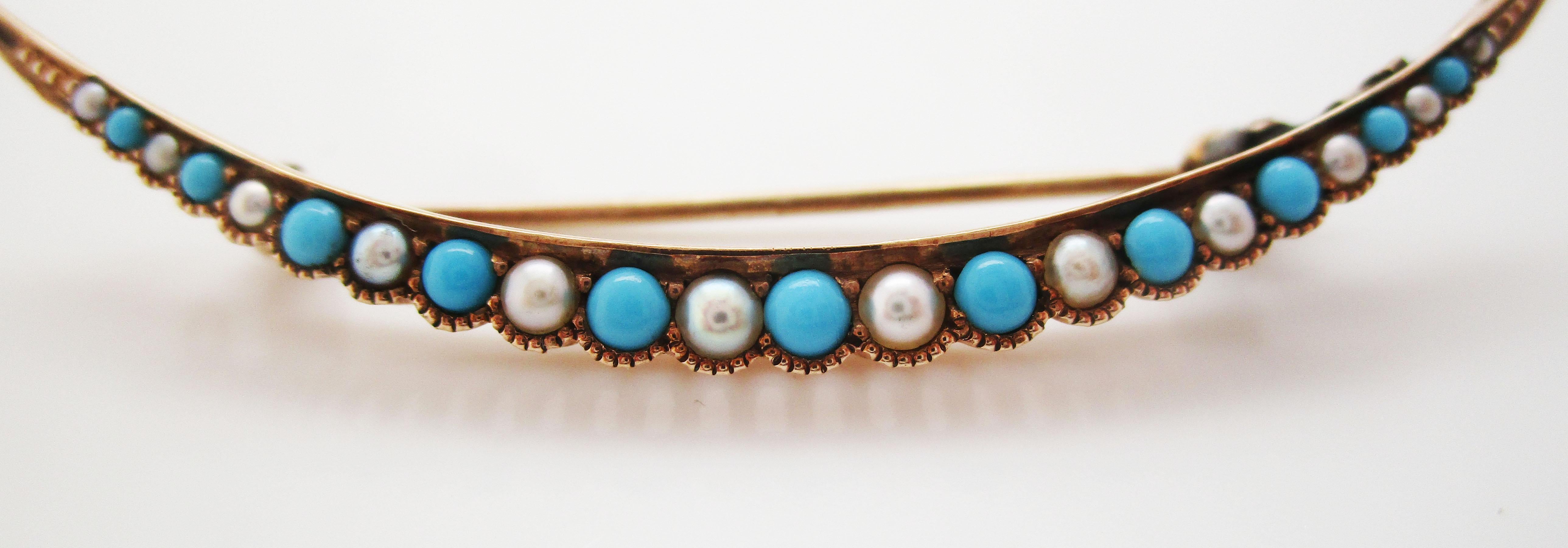 This is a beautiful Victorian pin from the 1880s in 14k yellow gold and featuring a gorgeous row of turquoise cabochons and stunning white seed pearls! The combination of pearls and Persian turquoise in yellow gold is a definitive Victorian look.