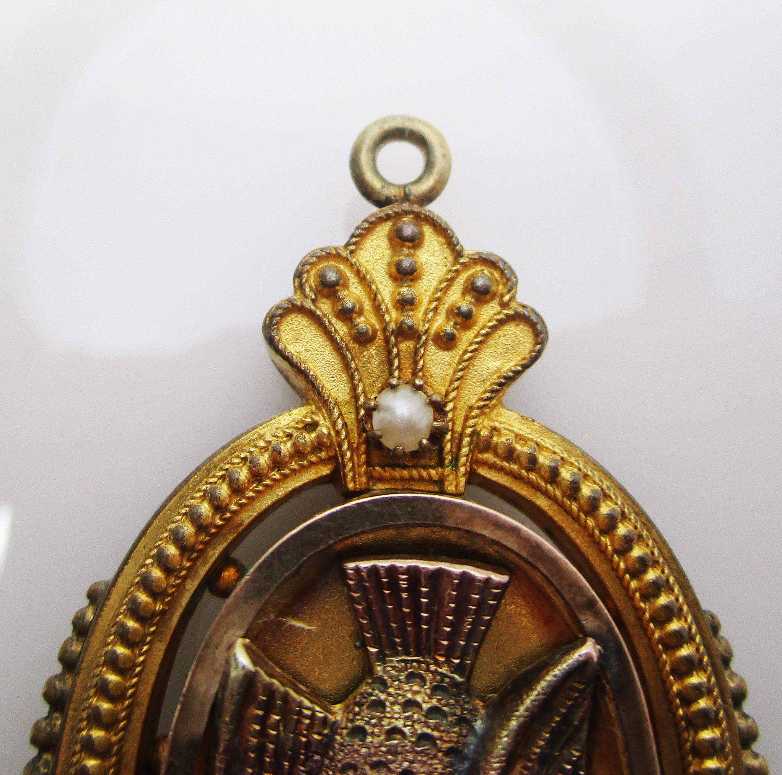 This is a gorgeous Victorian locket in bright yellow gold filled with a unique dove design and beautiful seed pearl accents! This locket has a bold layout with an excellent degree of depth. The center features an elegant dove detailed with a fine
