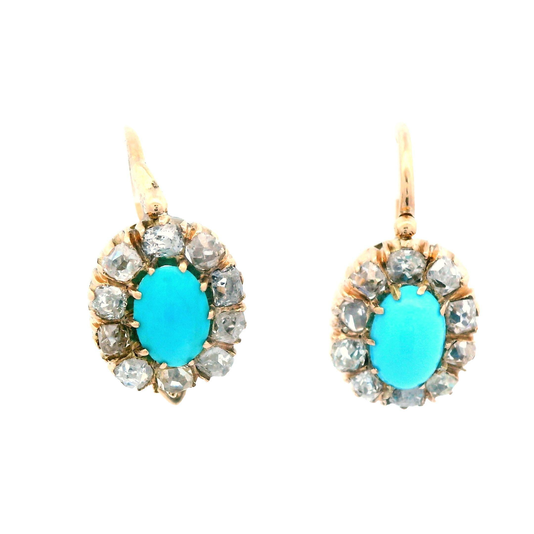 These gorgeous Victorian earrings are in 14k yellow gold and feature stunning Persian turquoise centers framed by bright white old mine cut diamonds and a full set of Imperial Russian hallmarks. The earrings have a classic drop layout that boasts a