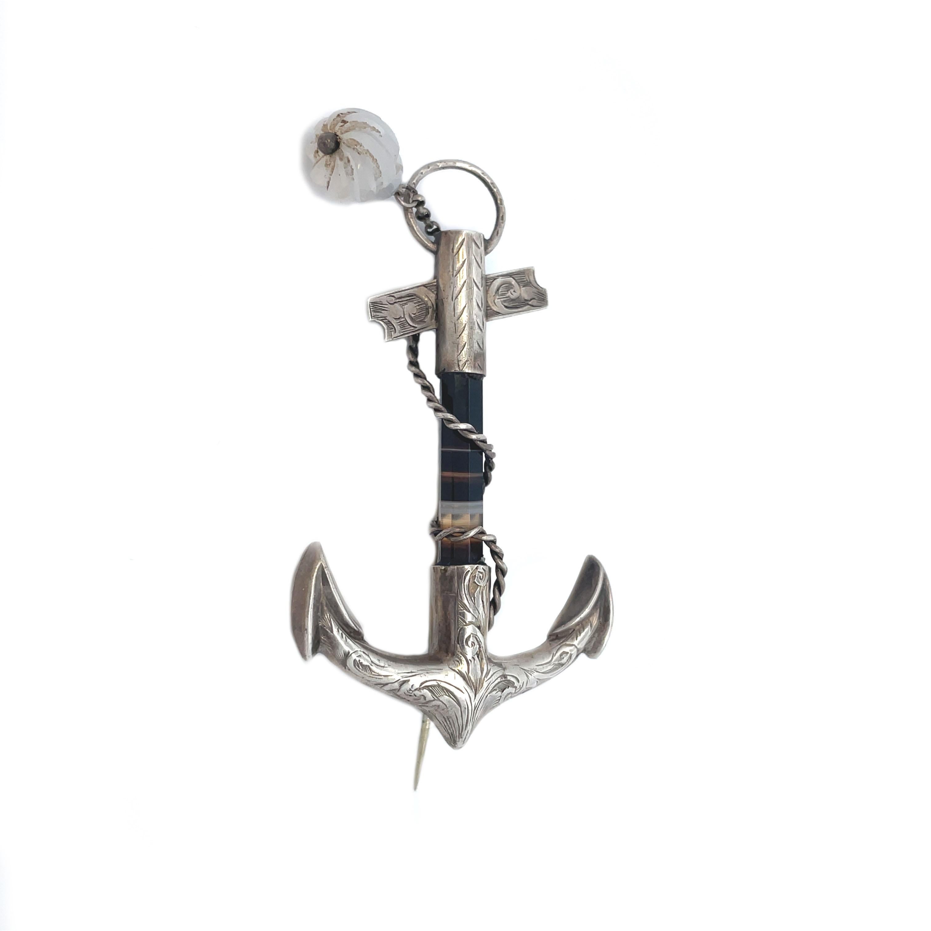 This is a unique 1880 Victorian anchor pin crafted in Sterling Silver and set with Scottish Agate in the center. A stunning antique anchor brooch with a gorgeous banded agate & silver top and ends with hand engraved detailing. Anchors were